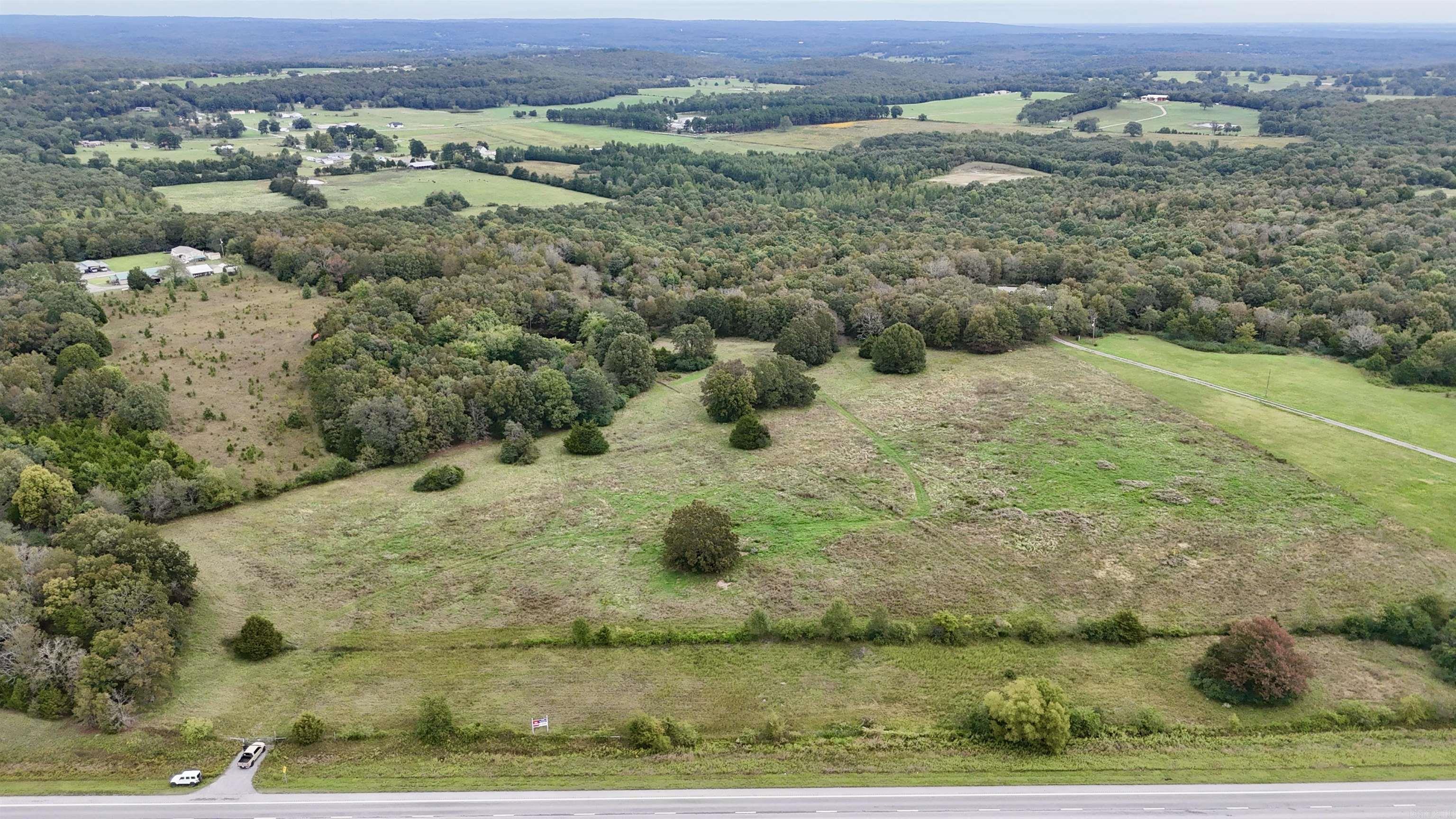 This beautiful property is a once in a life time buy. It is Owner financing with a 0% interest rate! Seller is requiring 10% ($42,000) down minimum but prefers $60,000 down. Seller is willing to finance out to 20 years and each monthly payment goes 100% to the principal. This land has the best of every world with over 1300' of highway frontage, approximately 24 acres of pasture with a pond, perfect for cattle or even for building you dream home. 40 acres are wooded with creeks and hill. It has not been hunted in 25 years so the wildlife is everywhere. It is an oasis for deer and turkey. The owner has also seen fox, ground hog, quail, dove, and rabbit throughout the land. Don't miss out on this unique opportunity for 0% interest rate and for your dream property for hunting, cattle, or your dream home.