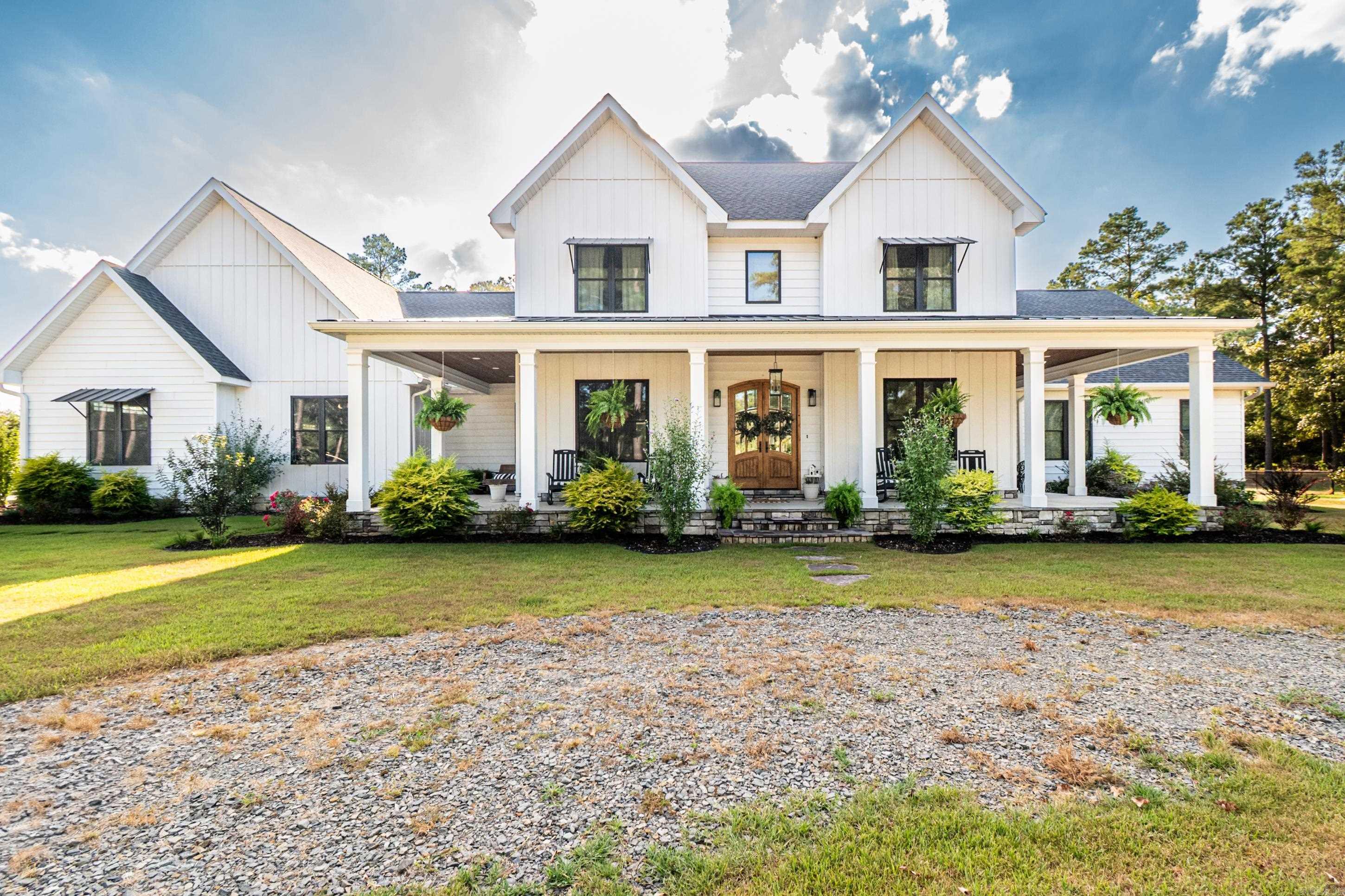 Welcome to this beautiful new buildāa one-of-a-kind custom modern farmhouse offering over 4,300 square feet of thoughtfully designed living space. This open-concept home combines timeless charm with modern convenience, featuring quartz countertops, tile floors with the look of hardwood, and premium finishes throughout. Highlights of the Home: Two spacious downstairs master suites with oversized walk-in closets Expansive kitchen with walk-in pantry and quartz countertops Dedicated office and secure saferoom for peace of mind Two tankless hot water heaters for endless efficiency Three-car garage with plenty of storage space Large floored attic for additional storage Outdoor Living & Amenities: Sparkling pool with accompanying pool house Inviting outdoor kitchen and fireplaceāperfect for entertaining Set on 7.37 private acres, offering both space and serenity Bonus Feature: A fully finished working beauty shopāideal for a beautician, dog groomer, or easily transformed into a game room, hobby space, or home business. This home truly has it allāstyle, space, and versatilityādesigned for modern living while embracing the warmth of farmhouse charm.