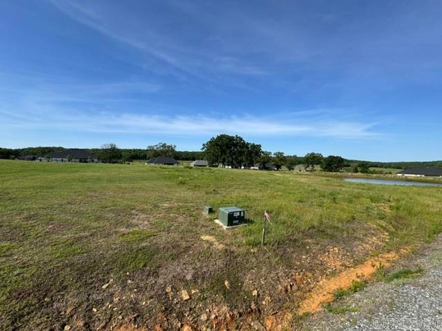 Nice, cleared lot with a pond in an excellent subdivision.