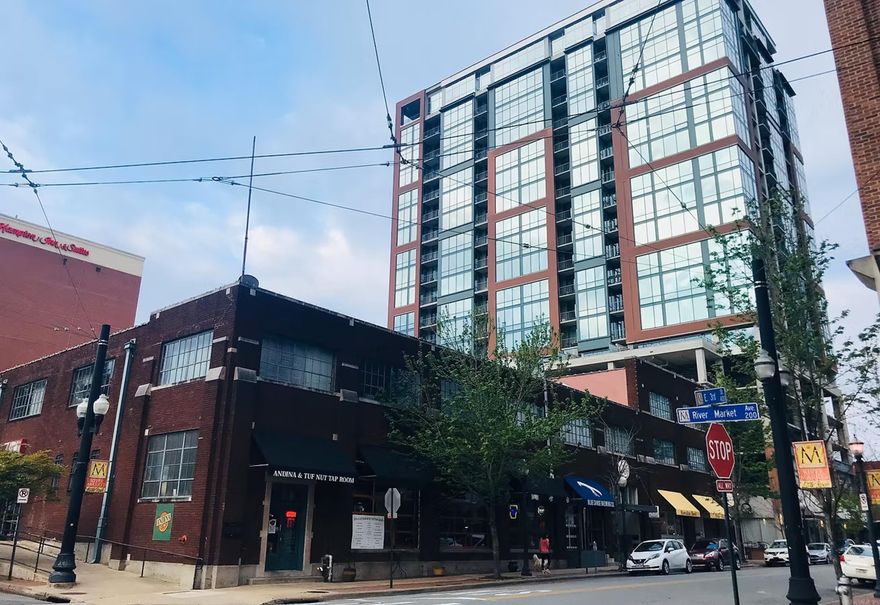 SEVEN DOWNTOWN STUDIO LOFTS! Step into the vibrant energy of downtown with this rare opportunity. Located in the iconic Tuf Nut Lofts—formerly home to the legendary blue jean factory. Now officially listed on the National Historic Register, the building showcases post and beam construction, soaring 15-foot ceilings, and exposed brick walls that echo its storied past.  Located within unbeatable walking distance to the River Market, River Trail, local gyms, parks, restaurants, and more, this space delivers on location, lifestyle, and legacy. Lofts are one bedroom, one bathroom located on the interior of the 2nd floor. Units 216-223. Unit 223 is leased by a long time tenant. Sizes range from 500-600 sq ft.