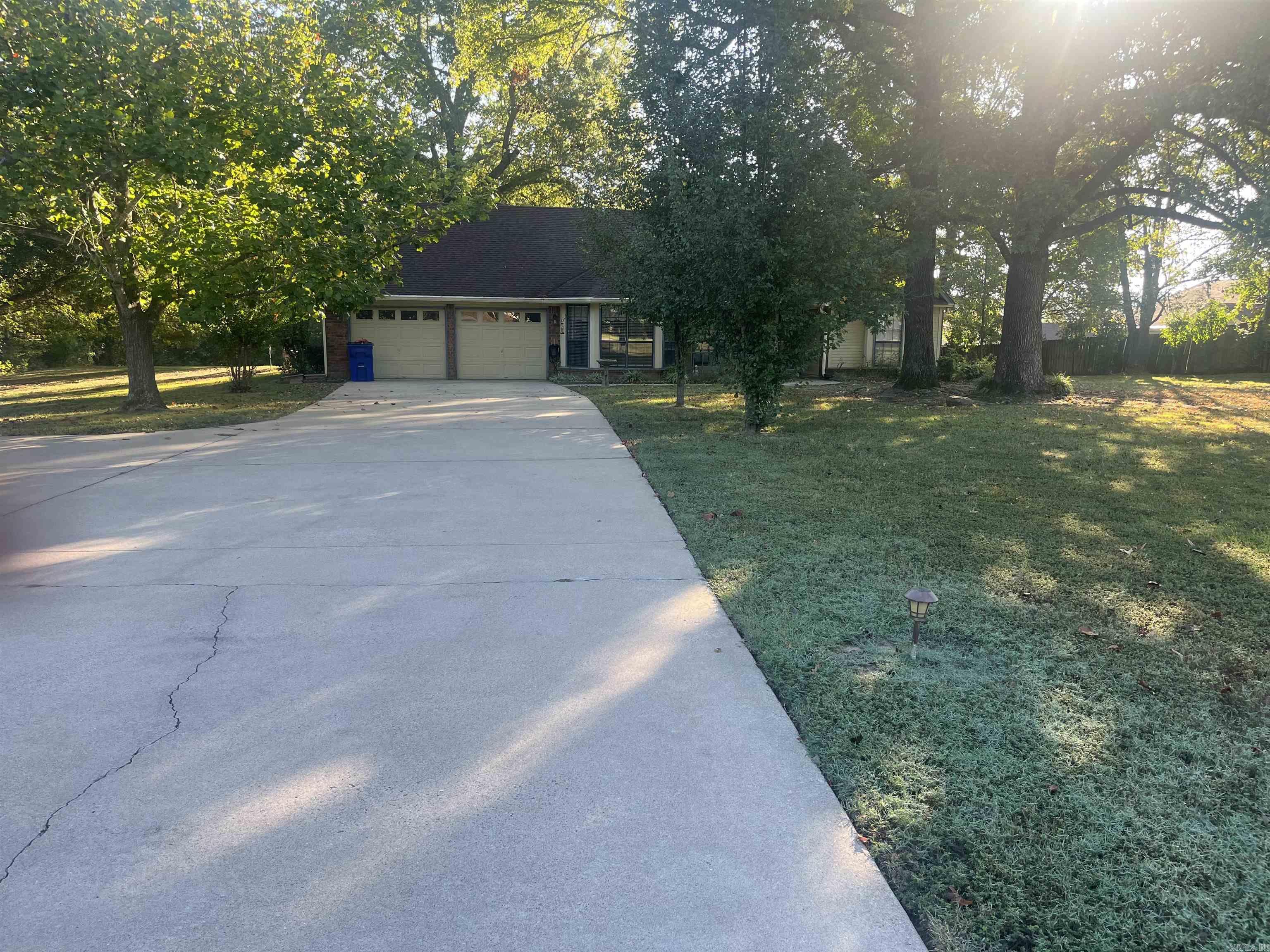 Beautiful established neighborhood with gorgeous trees close to everything! Split floor plan with wood burning fireplace! Huge master bedroom and living room! Large formal dining room and laundry room! Nice sized living and master bedroom with walk in closet! Huge 1.22 acre lot in town! Home even features a covered back porch with storm cellar and good size storage building! A must see home!