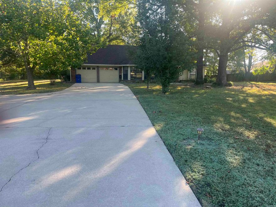 Beautiful established neighborhood with gorgeous trees close to everything! Split floor plan with wood burning fireplace! Huge master bedroom and living room! Large formal dining room and laundry room! Nice sized living and master bedroom with walk in closet! Huge 1.22 acre lot in town! Home even features a covered back porch with storm cellar and good size storage building! A must see home!