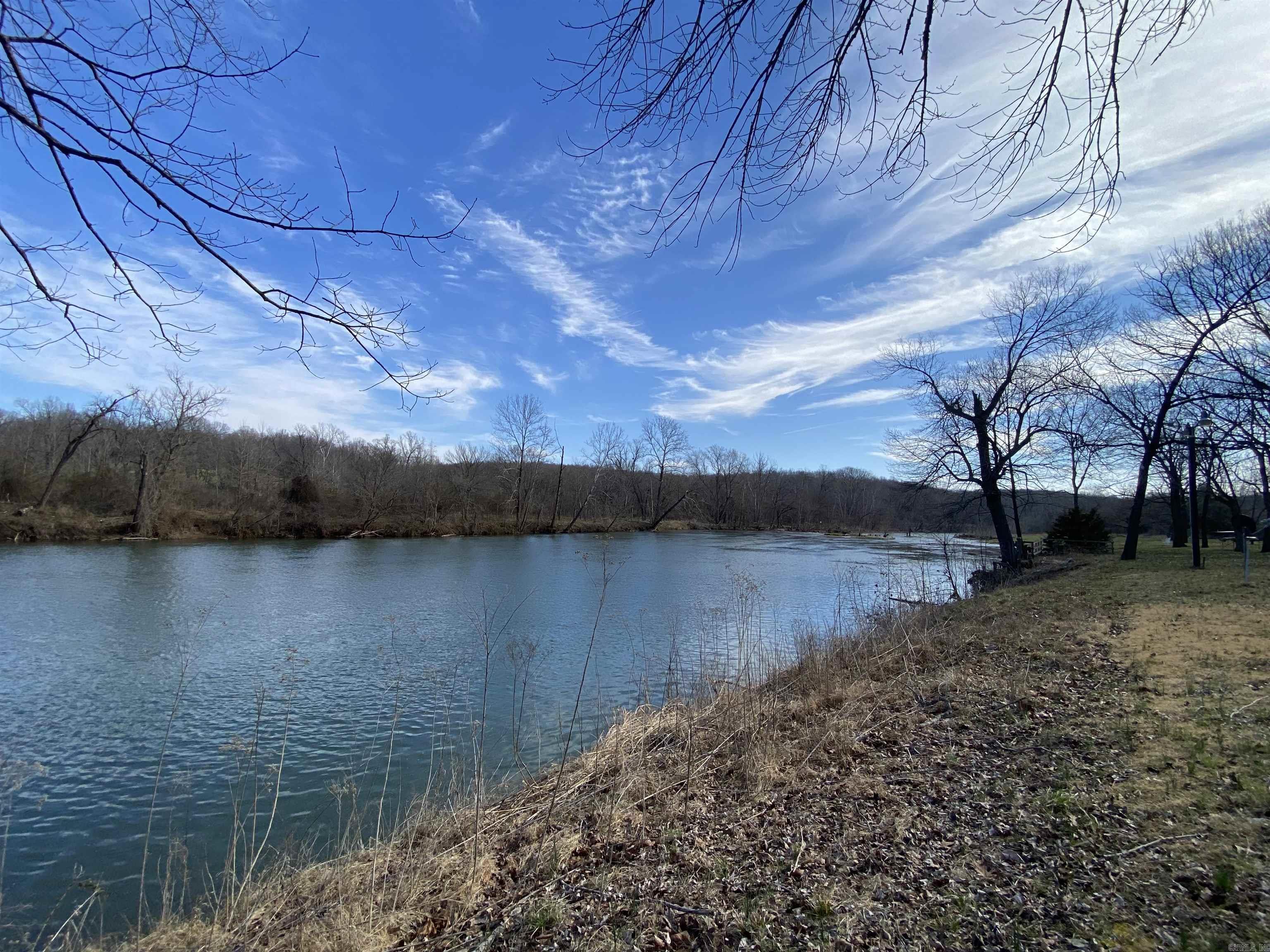 EMBRACE THE TRANQUILITY OF RIVERFRONT LIVING and build your own cabin on the serene banks of the Spring River. This remarkable property provides the canvas for your dream retreat, complete with a rare and essential feature: electricity is already in place, ensuring convenience and modern comfort as you design your riverside haven. The possibilities are endless w/this gem. Whether you envision a cozy weekend getaway, year-round residence, or an investment opportunity. With the river at your doorstep, fishing, kayaking, and simply enjoying the serenity of the water are just a step away. The allure of a cabin on Spring River w/existing electricity & breathtaking views is a rare find. Create the life you've always dreamed of. Make your vision a reality today, and let this property become your private retreat.