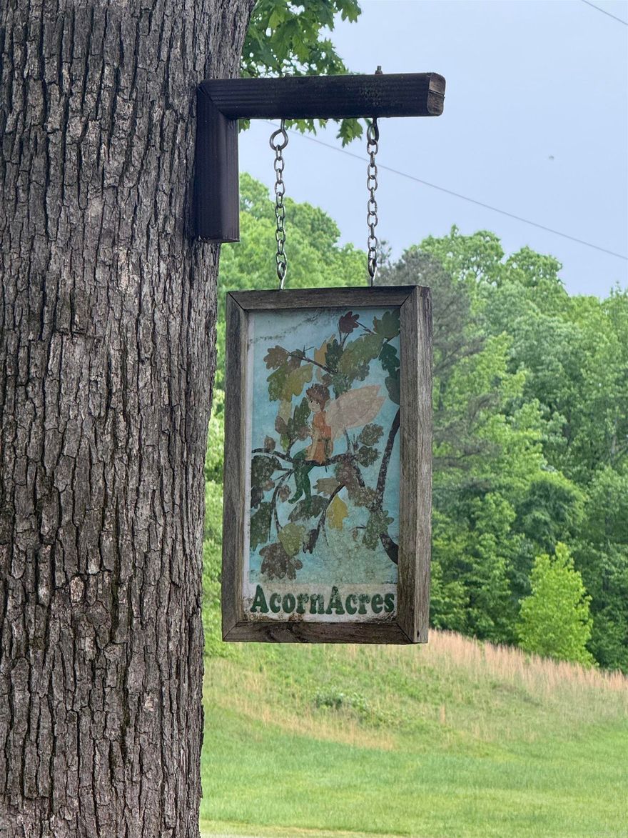 Welcome to Acorn Acres! This 11.61-acre property is a homesteader's dream, featuring a well-maintained 3-bedroom, 2-bathroom doublewide mobile home on a permanent foundation. The residence offers spacious living areas, including a wood-burning fireplace in the den and a gas fireplace in the main living room.  The property is designed for a self-sustaining lifestyle, complete with fruit-bearing trees, herb gardens, and established pollination plants to support local wildlife. The infrastructure includes 13 garden beds, a custom greenhouse, a canning shed, a smokehouse, certified inground storm shelter and a shipping container equipped with AC. Multiple additional outbuildings provide ample storage for equipment and livestock feed.   Nature enthusiasts will appreciate the abundance of wild medicinal and culinary herbs, forageable mushrooms, and a stocked fishing pond. Conveniently located near both Benton and Hot Springs, this property also includes a two-car carport with storage, and an additional single carport.  Acorn Acres offers a unique opportunity for high-quality country living.