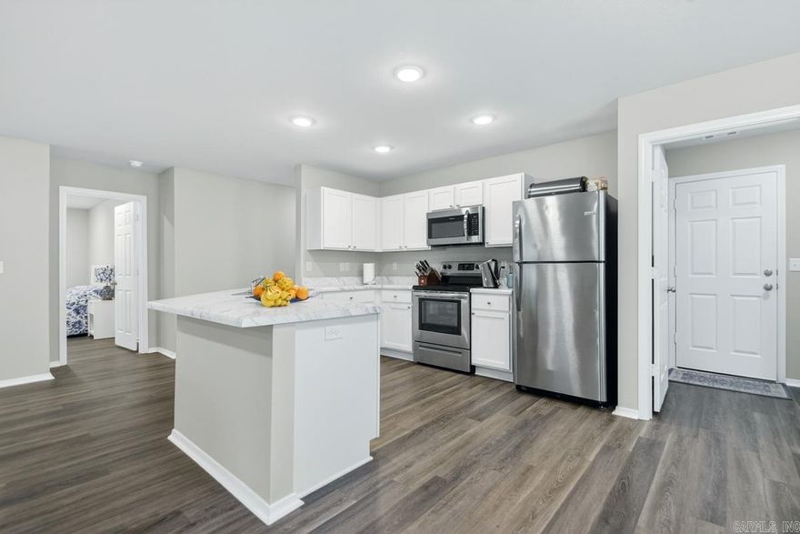 WELCOME HOME! This home is move in ready! Offering 1470 square feet of modern, thoughtfully designed living space. This 3 bedroom, 2 bathroom home features an inviting open floorpan that seamlessly connects the living, dining, and kitchen areas- perfect for both everyday living or entertaining.    The Kitchen is the heart of the home, boasting sleek finishes, ample cabinets and a spacious layout that flows effortlessly into the main living area filled with natural light. The split-bedroom design provides privacy, with a comfortable primary suite featuring a private bath and a generous closet with additional storage with shelving in the bathroom.     Enjoy the convenience of a newer construction , built in 2022, low maintenance living.  The refrigerator, washer and dryer, outdoor cameras,  all convey with the home adding extra value and making your move even easier!  Additional upgrades are flooring, added upper cabinets in laundry, extra lighting with dimmers throughout home, floored attic for storage, shelves added to linen closet in primary suite. Entire video surveillance conveys!  This home offers the perfect blend of comfort and style in a move in ready package