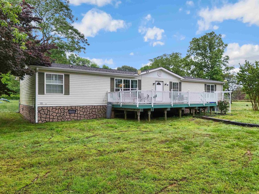 Discover the perfect blend of comfort and tranquility in this updated double-wide mobile home, ideally situated on a sprawling 4.76-acre parcel. Nestled on a permanent foundation, this property offers both stability and peace of mind. It’s more than just a home; it’s a lifestyle. The 4.76 acres of fully fenced land provide ample space for a variety of outdoor activities or future expansions. A separate shop offers the perfect space for hobbies, projects, or additional storage, catering to both practical needs and creative pursuits.  With ample land and fencing, this property is perfectly equipped to accommodate livestock, making it ideal for small-scale farming or those seeking a rural lifestyle.  Experience the peace and quiet of a secluded setting, away from the hustle and bustle of city life, yet still conveniently accessible. Whether you’re looking to escape the city, start a small farm, or simply enjoy more space and privacy, this home is ready to meet your needs. Be sure to check out the aerial drone footage and 3D tour.  See confidential remarks for showing instructions.