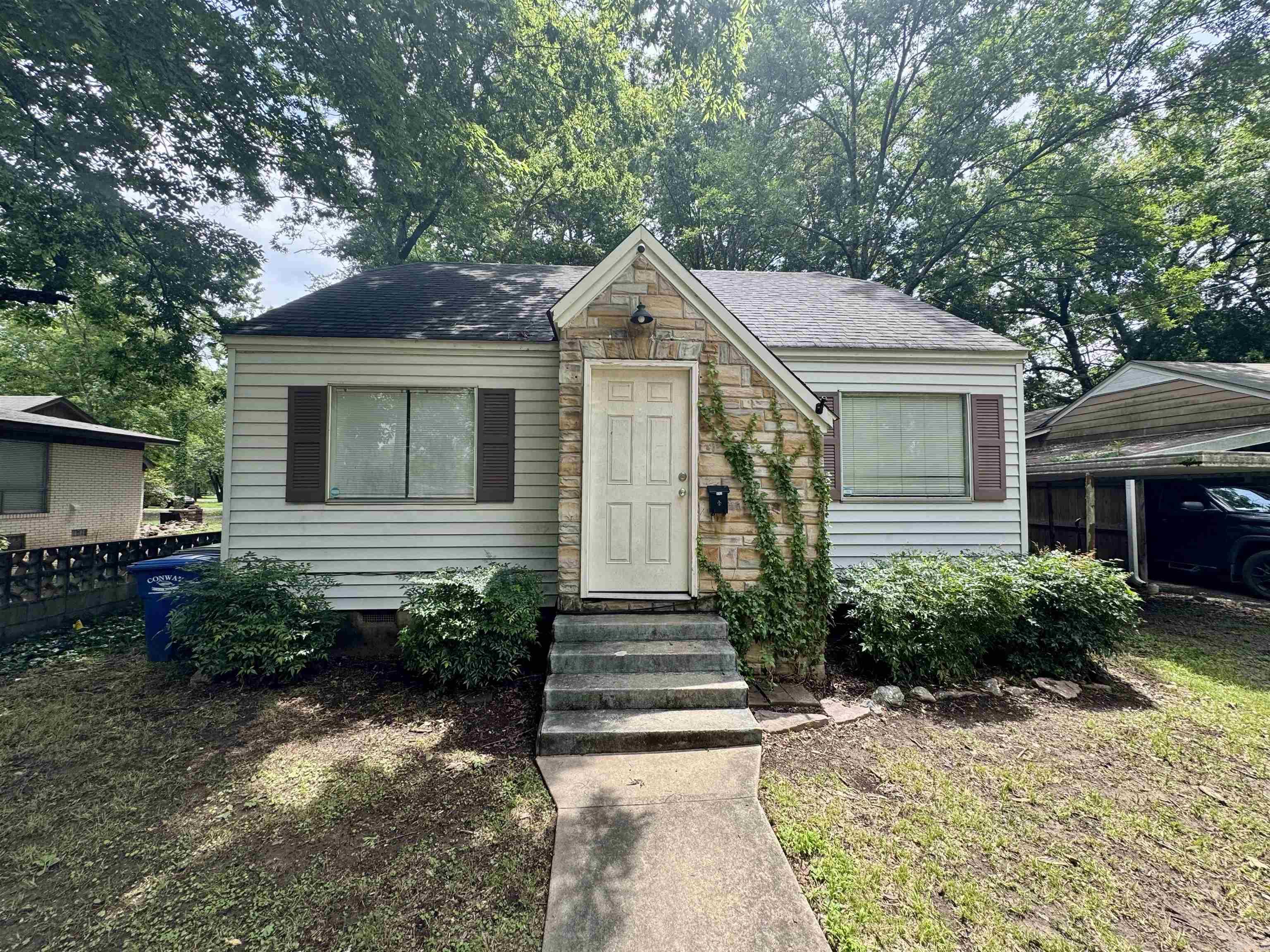 Charming and full of character, this 2-bedroom, 1-bath 1947 cottage in Downtown Conway offers original hardwood floors, a cozy living area, and a galley-style kitchen with included refrigerator and laundry hookups. Situated on a fenced lot with a covered carport and storm shelter, it’s just minutes from UCA, Hendrix College, parks, and local dining. Schedule your showing today!