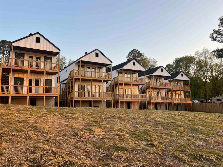 Welcome to Boll Estates II! These luxury townhomes have the best views on beautiful Lake Hamilton with their own private boardwalk, pier, and sun deck. The first floor has a spacious two car garage and an open floor plan. Enjoy taking in the lake views from your kitchen and the adjoining living room which has floor to ceiling Andersen 100 windows and doors that open up to your large deck.  The second floor hosts the master bedroom with vaulted ceilings and more floor to ceiling Andersen 100 windows and doors which also has its own private deck. A spacious ensuite with a large master closet and plenty of storage space. Laundry room is conveniently on the same floor as the bedrooms. Great as an investment property or main residence. No short term rental restrictions. *Pool not included.