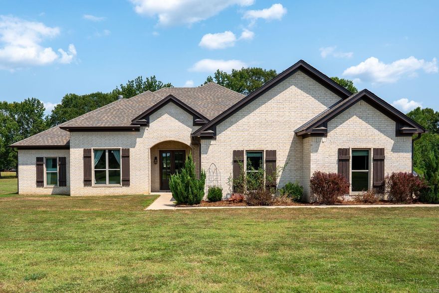 Stunning 4-bedroom, 2.5-bath custom-built home on 3 level acres with a 30x30 metal shop built in 2020. The welcoming foyer opens into a spacious living room centered around a cozy wood-burning fireplace. The open-concept kitchen features a large granite island, double ovens, and an oversized walk-in pantry offering incredible storage. Adjacent to the kitchen, the dining area includes built-in bench seating and beautiful windows with a view of the backyard. The split bedroom layout includes a large primary suite with a soaking tub, walk-in shower, dual vanities, one with a dedicated makeup vanity, and a generous walk-in closet. Three additional bedrooms all feature walk-in closets and share a well-appointed hall bath with double sinks, a tub/shower combo, and a large linen closet. The outdoor living area boasts a spacious yard, two-car garage, and ample parking. The detached large metal shop has electricity and 14-ft ceilings.