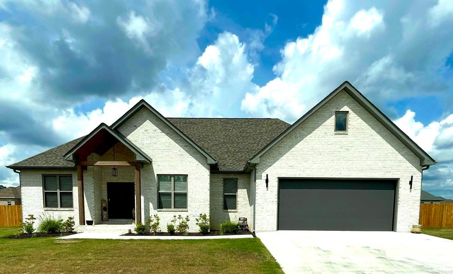 4/2 NEW BUILD LESS THAN 1 YEAR OLD IN DESIRABLE JACOB CREEK SUBDIVISION WITH BUILDER'S WARRANTY IN EFFECT THROUGH 02/27/26. This fully fenced all brick home sits on 0.36 of an acre and has an oversized 2 car garage with storage room.  Inside the home, the great room boasts 10' ceilings and  is open to the kitchen and dining area while overlooking the covered outdoor patio with retractable sun shades. The quartz countertops flow into the amazing laundry room filled with built in storage and folding area.  The primary bedroom is spacious with a luxury primary bath with spa like atmosphere  featuring both a soaking tub and oversized walk in shower, as well as his and hers walk-in closets. Back outside, the driveway will hold an additional 4-6 vehicles while the privacy fence with 12 foot gate provides easy access for your toys. The game day porch has room for both seating and dining as well as a designated grilling area. WELCOME HOME to 125 Allie Jo Lane.  You're going to love it here!