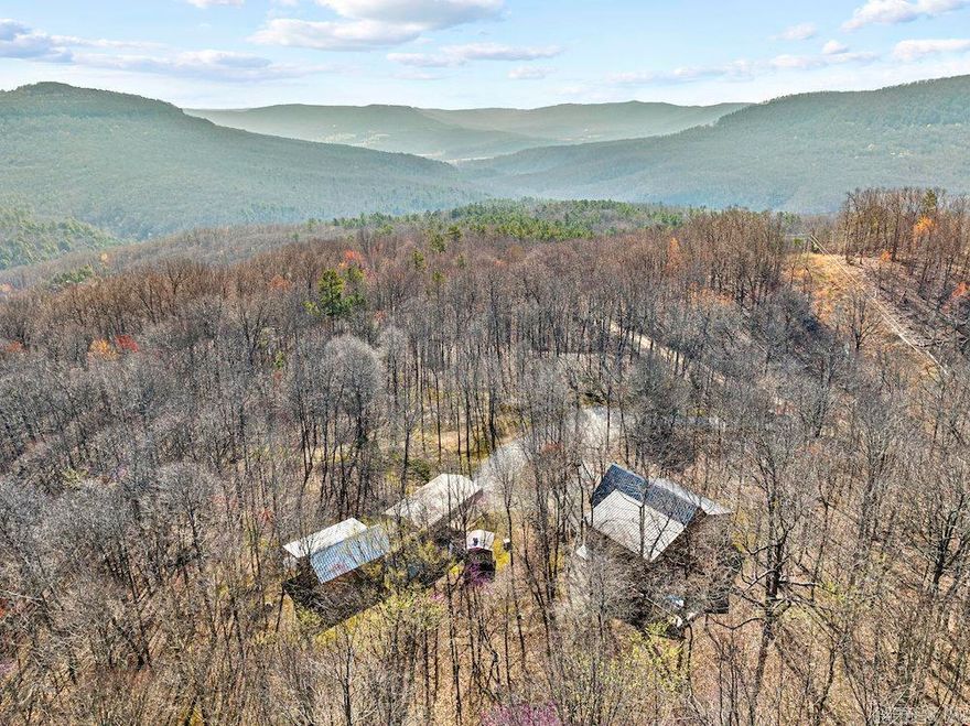 This majestic and wonderfully built masterpiece of a cabin is set on a stunning wooded tract located in the heart of Newton Co. at the epicenter of the Ozarks. The property is near Mt. Sherman, AR, Horseshoe Canyon Ranch, Jasper, AR, & the famous Buffalo National River. Built in 2011, the main cabin is a site to behold; and no detail was overlooked, & no expense was spared. The space is just over 2,400 sq ft and sports a massive front-covered porch, a large back deck, & some gorgeous rockwork. A bonus climate-controlled basement storage area is complete with a utility sink, storage space, & all the mechanical equipment. Extra attention was paid to the outdoor storage space under part of the cabin, which has a gravel base as well. The custom wood trim and wood beams add a touch of rustic elegance to the outside of the cabin. Set next to the main cabin is a recently built bonus cabin for additional space for guests. This 500 sq ft cabin was also constructed with similar materials & quality. The cabin has an immense amount of charm with vinyl plank flooring, wood accent walls, wrapped beams on a vaulted ceiling, a massive ceiling fan, a large bathroom, a storage room, & ample windows.