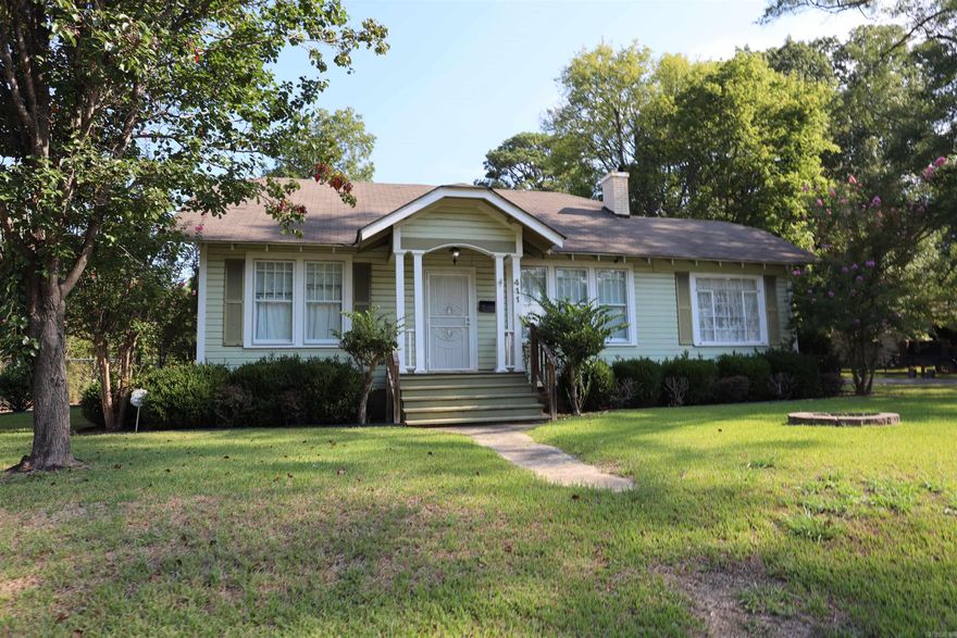 Welcome to this well maintained 1974 home offering 3 bedrooms, 2 bathrooms, and approximately 1,964 square feet of comfortable living space. Situated on a desirable corner lot inside city limits, this property boasts both charm and functionality. Inside, you'll find hardwood floors throughout much of the home, complemented by sheetrock walls and ceilings. A cozy gas fireplace adds warmth and ambiance to the living area. The home includes two bonus rooms, one being in the floored attic.  Step outside to enjoy the large back porch overlooking a spacious, fenced in backyard, ideal for entertaining, pets, or gardening. Two outbuildings offer great storage, including one with a convenient roll up door for equipment or workshop use.