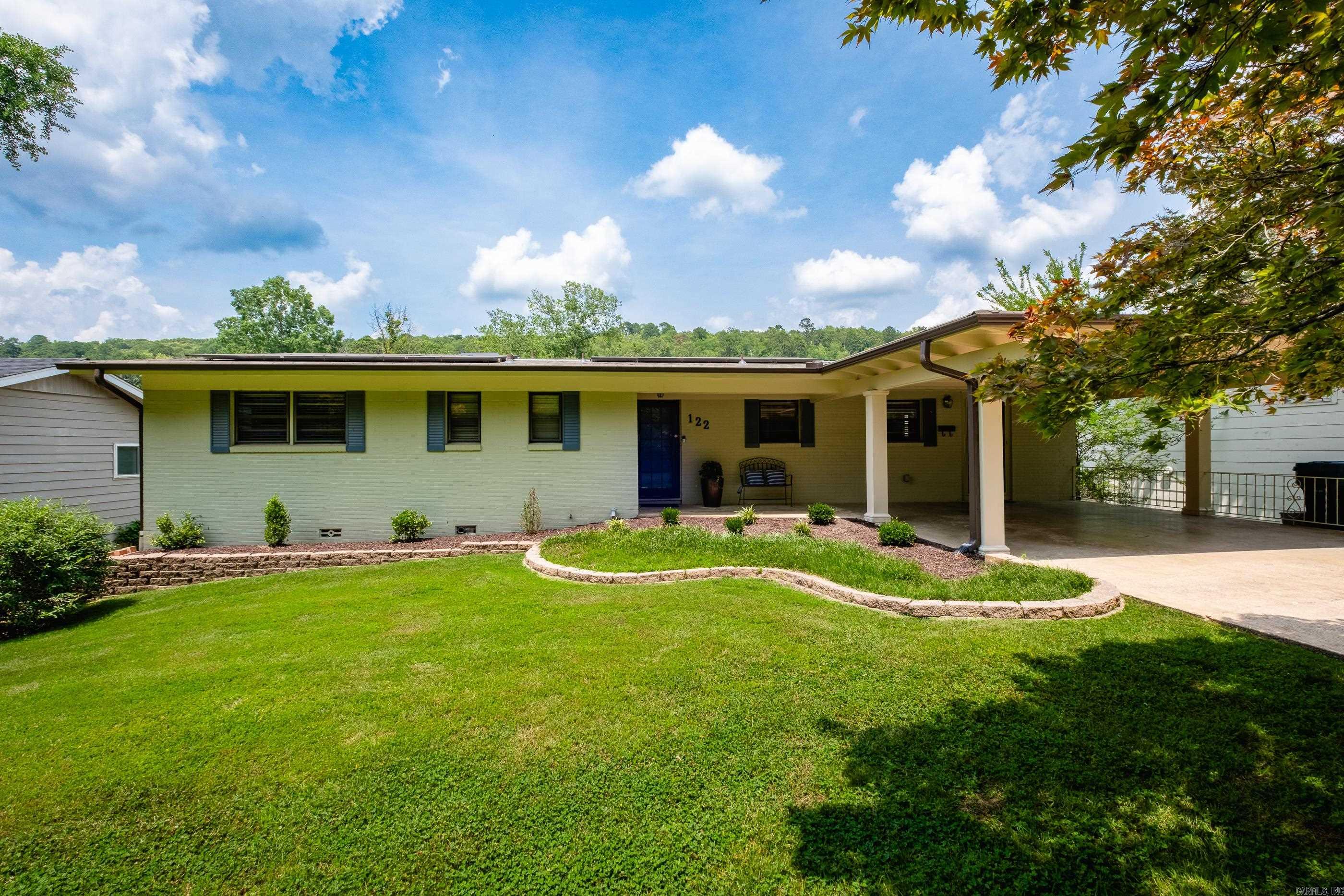 Located in the desirable Kingwood neighborhood, this home is a beautifully updated 4-bedroom, 2.5-bath home blending charm with modern upgrades. The renovated kitchen features granite countertops, a tile backsplash, tile flooring, and stainless steel appliances—perfect for home chefs and entertainers alike. Extensive 2023 updates include a new roof, new fencing, solar panels (average electric bill approx. $13/month in 2024–2025), new deck, gutters, and a renovated half-bath. The home showcases original hardwood floors upstairs and new luxury vinyl plank flooring downstairs, offering both character and durability. Enjoy the convenience of a 20x20 covered carport, an automatic sprinkler system, and approximately 700 square feet of basement/storage/utility space. The backyard sewer line was replaced in 2021. This move-in-ready home is just minutes from shops, parks, and restaurants. A rare find in one of Little Rock's most established neighborhoods!