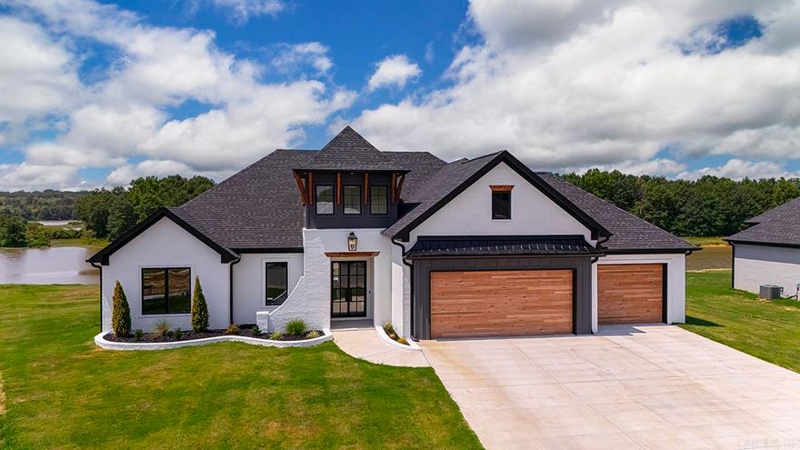 Welcome to luxury lake living at its finest. This stunning 4-bedroom, 2.5-bath custom home by Hunter Medlock Homes combines thoughtful design, elevated finishes, and everyday functionality.  From the moment you walk in, you’re greeted by soaring high ceilings and an open, airy layout that perfectly showcases the home’s custom craftsmanship. Every detail has been carefully curated—from the high-end lighting selections to the designer finishes throughout—creating a space that feels both sophisticated and inviting.  The spacious living areas flow seamlessly into a beautifully designed kitchen and dining space, ideal for entertaining or quiet nights at home. The oversized 3-car garage offers ample room for vehicles, storage, or even a workshop setup.  Step outside and take in the true showstopper—situated on the lake, this property boasts a massive yard with endless possibilities for outdoor living, entertaining, or simply enjoying peaceful waterfront views.