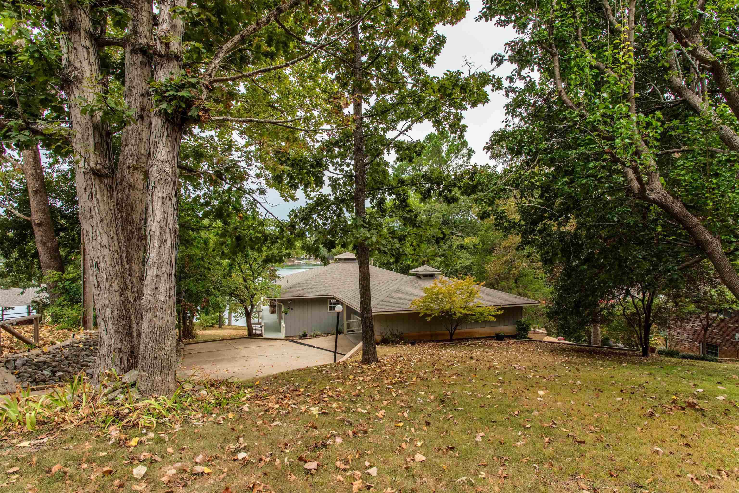 Perfect spot for a Lake Thunderbird home, just inside a cove. Natural light is abundant with all the windows! The main level of this home has everything you need-kitchen, living, primary suite, laundry, half bath and second bdr. Living room has tray ceilings & a gas fireplace to warm up on cool nights. Lower level has 2 more bedrooms, another bath, family room w/kitchenette and HUGE storage/utility room. Home has had recent updates include roof '23, air' 24, dock '24 and deck '23. There are two HVAC units, so not cooling/heating basement when no company in town. 3 of the 4 bedrooms have views of the lake, plus walk out to decks from living areas & primary bdr. Tons of cabinet and countertop space in the kitchen with built in desk, island w/glass top stove & walk in pantry. List price includes stove, fridge, dw, ice maker AND w/d!. Outside you'll find 2 car carport with additional storage and walkaway/stairs to the dock. Furniture is negotiable. Thunderbird Center w/pool. park and minigolf is just down the street, only a few more blocks to town center. Low traffic area due to street ending in another home. Come and see it before its gone!