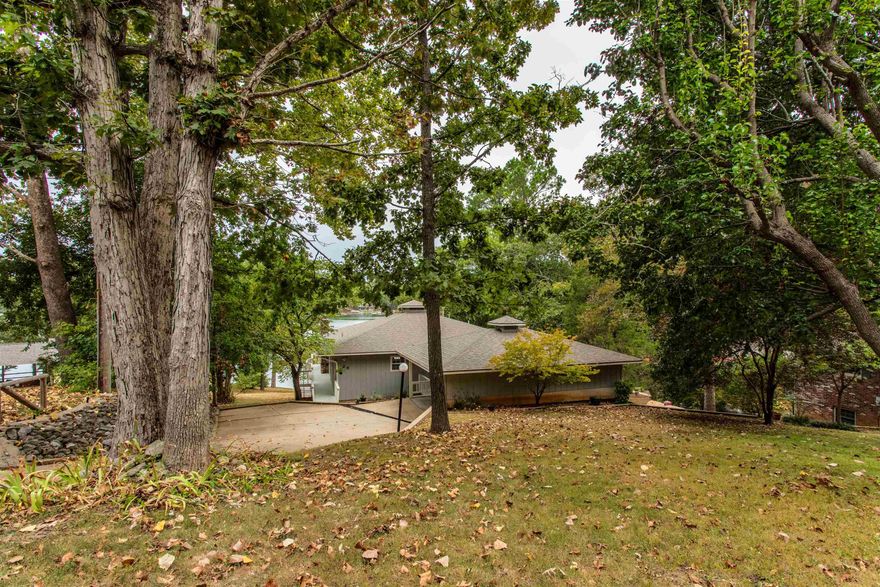 Perfect spot for a Lake Thunderbird home, just inside a cove. Natural light is abundant with all the windows! The main level of this home has everything you need-kitchen, living, primary suite, laundry, half bath and second bdr. Living room has tray ceilings & a gas fireplace to warm up on cool nights. Lower level has 2 more bedrooms, another bath, family room w/kitchenette and HUGE storage/utility room. Home has had recent updates include roof '23, air' 24, dock '24 and deck '23. There are two HVAC units, so not cooling/heating basement when no company in town. 3 of the 4 bedrooms have views of the lake, plus walk out to decks from living areas & primary bdr. Tons of cabinet and countertop space in the kitchen with built in desk, island w/glass top stove & walk in pantry. List price includes stove, fridge, dw, ice maker AND w/d!. Outside you'll find 2 car carport with additional storage and walkaway/stairs to the dock. Furniture is negotiable. Thunderbird Center w/pool. park and minigolf is just down the street, only a few more blocks to town center. Low traffic area due to street ending in another home. Come and see it before its gone! Check out virtual tour