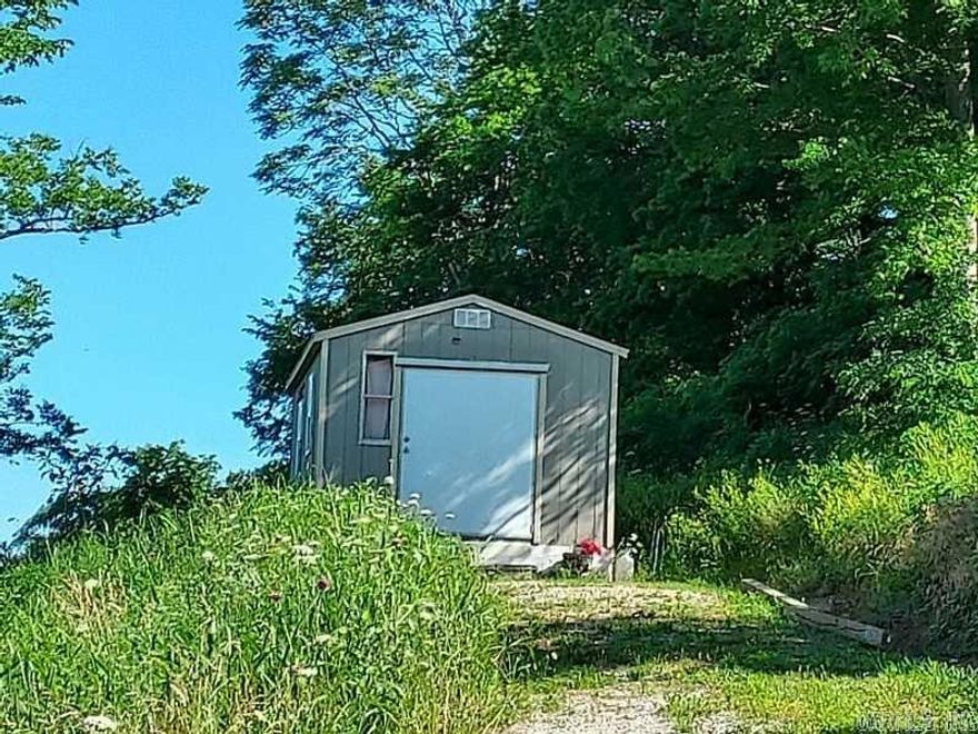 If you are looking for and affordable get-away with a Beautiful View, take a look. Just minutes from the famous court-square and music, shopping, restaurants but in a private setting. This is a lovely parcel of property with small fixer upper cottage, setting on a hill with a view you have to see to appreciate.