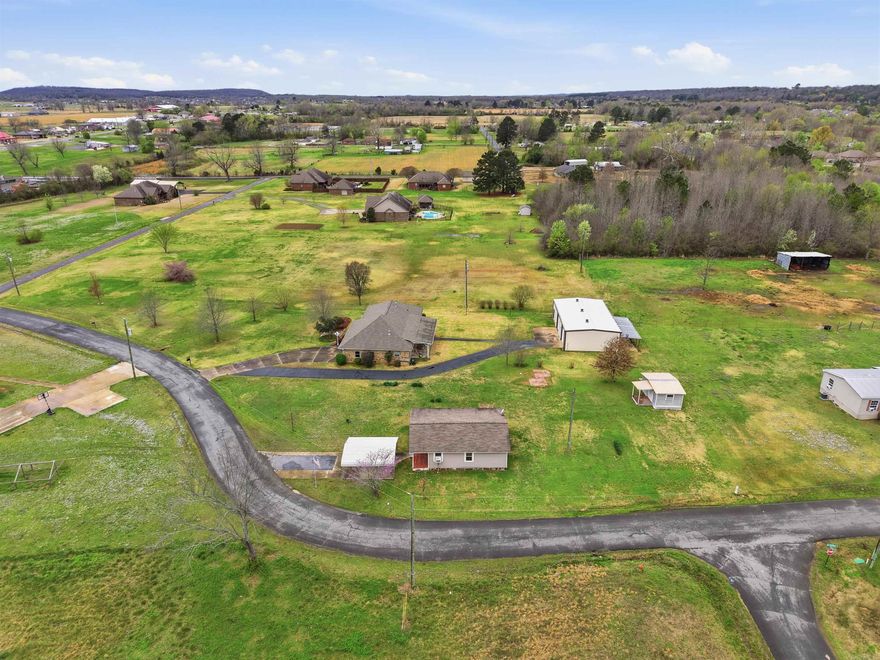 Rare opportunity for country living with extra space & versatility! Situated on 1.25 acres, this property features a well maintained 3 bedroom, 2 bath main home that has 1653sf heated & cooled along with a separate in-law quarters that includes 1002sf -3BR/1BA space. The additional space is ideal for multi-generational living, guest space, rental potential, or a private home office setup.  The main home offers wood laminate flooring, granite counters, a gas range, tons of cabinet space in the kitchen, & a tiled walk in shower, windows, roof, flooring replaced in 2014. City water + a well for watering, 2car garage & the second living area has its own driveway w a 1 car metal carport.   Also outside you will find a 1200sf oversized shop w elec & an additional lean-to on the back perfect for equipment! There is also an additional storage building that conveys. The separate in-law quarters offers great potential and just needs a little updating to make it shine!   With room to spread out, multiple buildings, & flexible living arrangements, this property offers so much and is 30 min from LRAFB!   Agents see remarks