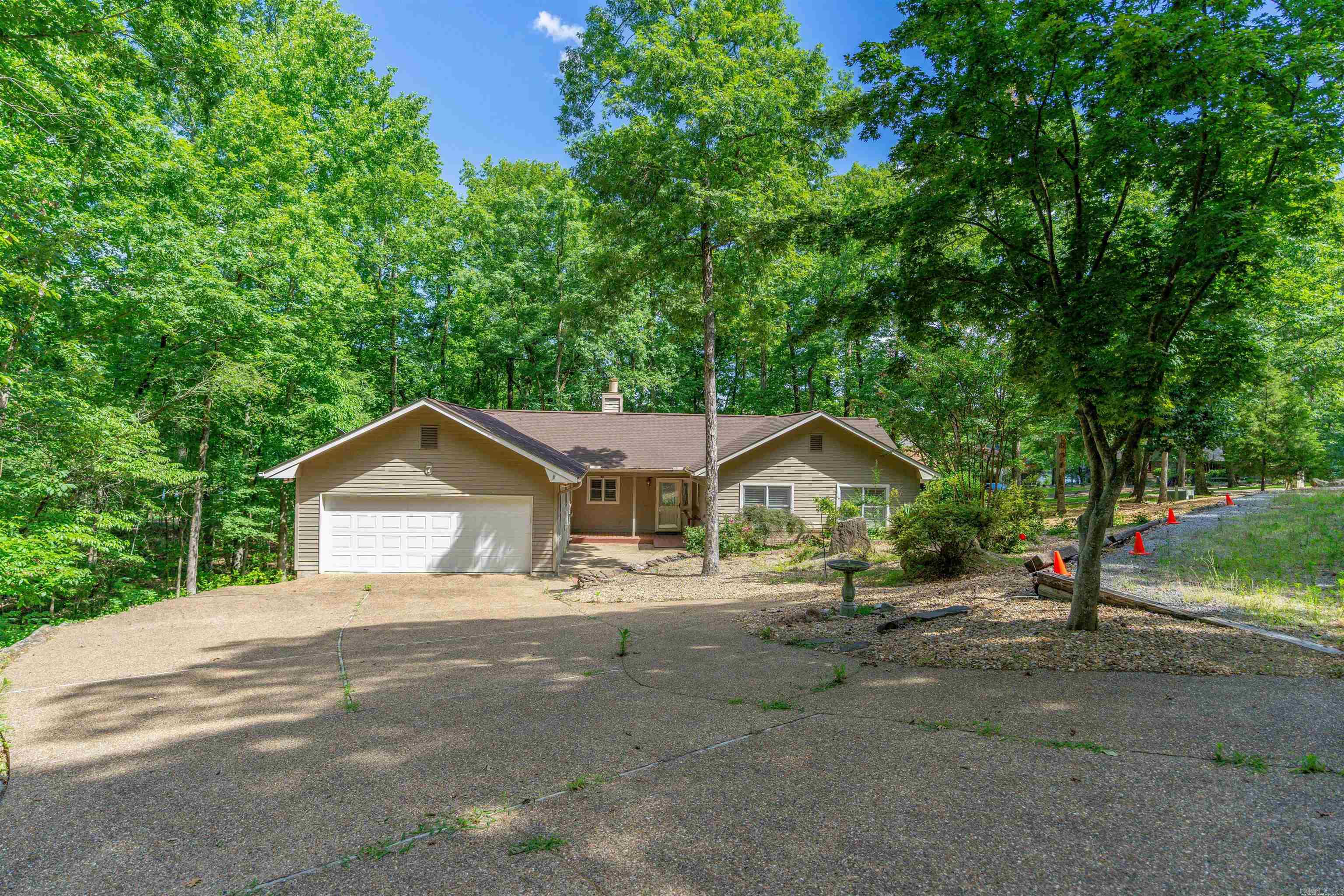 Views of Lake Coronado with year-round water views! Enjoy stunning views and lake access with this beautifully maintained home featuring common property to Lake Coronado. Freshly painted and move-in ready, this property offers a spacious Arkansas room and a large deck--perfect for entertaining or simply relaxing as you take in the tranquil, year-round water scenery. The kitchen boats elegant granite countertops, and the cozy living room includes a charming fireplace for cool evenings. With a two car garage and basement area for storage or workshop, this home combines comfort and convenience. Located just minutes from the Natatorium, tennis courts, and several premier golf courses, this is your ideal retreat for both recreation and relaxation. Don't miss this rare opportunity to live near the lake and enjoy all the amenities the area has to offer! AGENTS SEE REMARKS