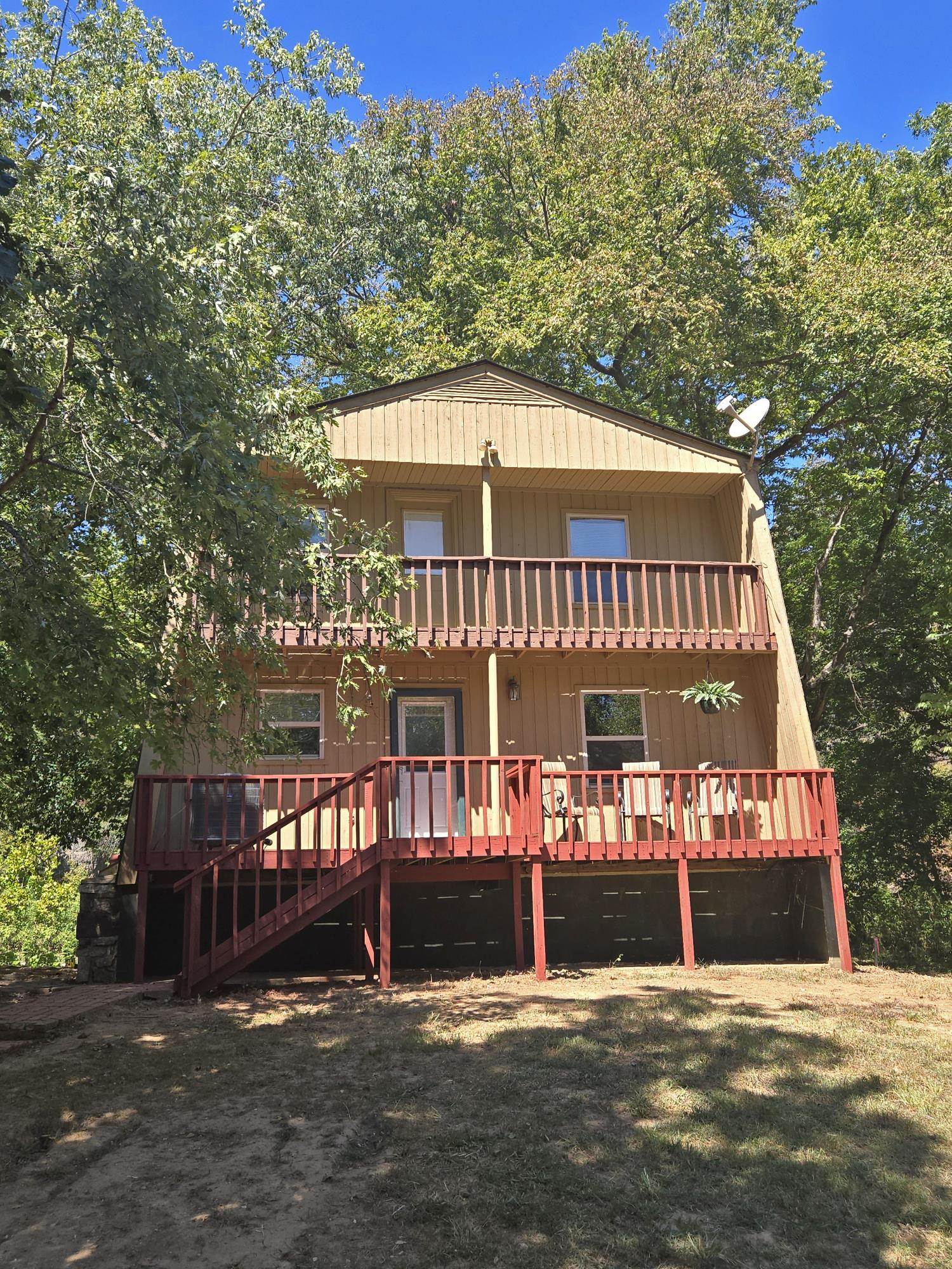 SOUTH FORK RIVER FRONT HOME with 60 feet of tranquil river frontage for fishing, swimming, and kayaking. 1668 square feet living space, 1148 on the main level and 520 upstairs, plus the full unfinished basement for large storage. This home is perfect for family living or a week-end getaway. Enjoy the wide river views from windows all around the sun room and the French door off the living room. There are wonderful decks both in front and back for BBQ nights or just for relaxing and watching the family enjoy the sights and sounds of South Fork flowing by. The 14x22 living room with natural stone wood burning fireplace, kitchen and dining area, sun room, primary bedroom and a full bath are on the main level. On the second level are two additional bedrooms, another full bath, and the loft area. New luxury vinyl flooring was installed this Spring on the main level, along with new stainless steel appliances... stove, refrigerator, microwave and dishwasher in the kitchen. Call for an appointment to see this wonderful river property.
