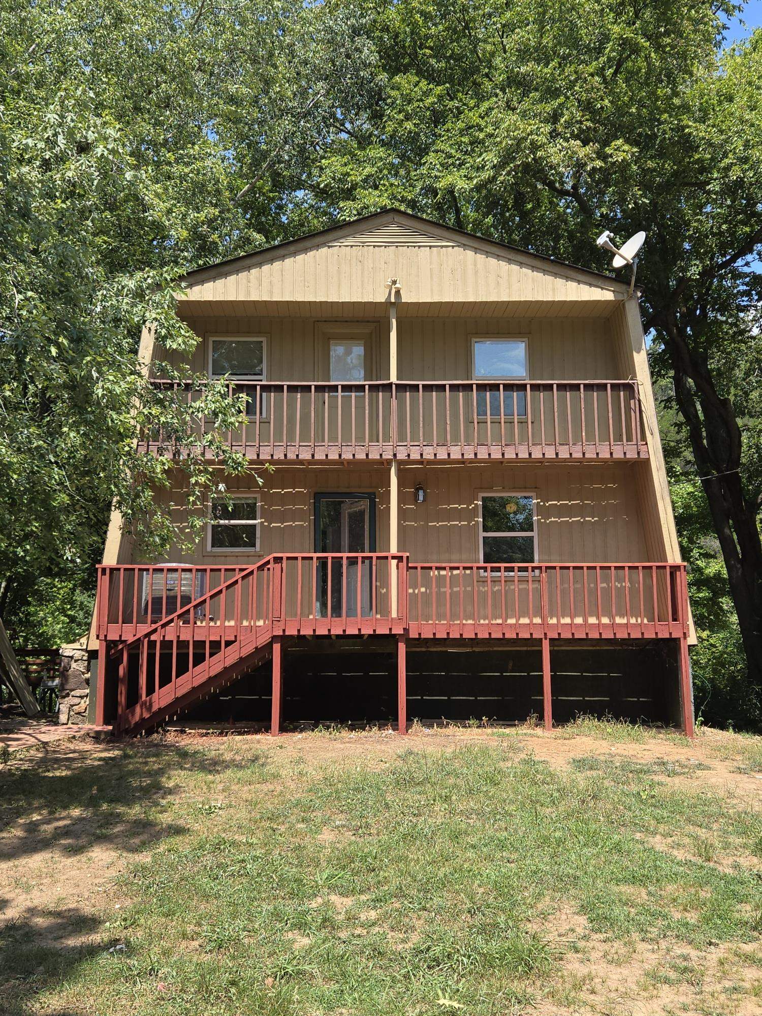 HARDY, ARKANSAS SOUTH FORK RIVERFRONT HOME - 60 feet of tranquil river frontage for fishing, swimming, or kayaking. 1668 square feet, 1148 on the main level and 520 upstairs, perfect for family living or week-end getaway. Enjoy the wide river view from the large windows all around the sun room and the French door off the living room. Wonderful decks both in front and back, good space for BBQ's or just watching the family enjoy the sights and sounds of South Fork. Master bedroom, full bath, kitchen, dining area, 14x22 living room with natural stone wood burning fireplace, and sun room on the main level. Two guest bedrooms, bath, and loft office/sitting area above, plus a full unfinished basement below for plenty of storage. New luxury vinyl flooring along with new stainless steel appliances in the kitchen, some new cabinetry and all new counter tops and interior paint on the main level. Call for an appointment to see this wonderful river home property.