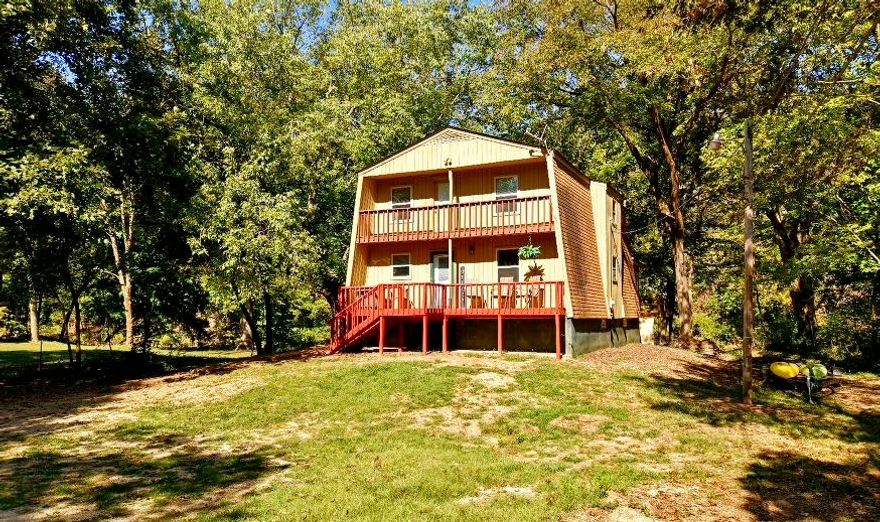 Discover the peaceful charm of riverfront living in this elegant SOUTH FORK RIVER FRONT HOME, offering 60 feet of tranquil water frontage perfect for fishing, swimming, and kayaking. With 1,668 square feet of inviting living space—1,148 on the main level and 520 upstairs—plus a full unfinished basement for generous storage, this home is ideal for comfortable family living or a serene weekend retreat.   Take in sweeping river views from the sunroom’s surrounding windows or through the French doors off the living room. Spacious decks at both the front and back of the home create perfect settings for summer BBQs, morning coffee, or quiet evenings listening to the soothing flow of the South Fork. Inside, the main level features a welcoming 14x22 living room with a natural stone wood-burning fireplace, an open kitchen and dining area, the sunroom, the primary bedroom, and a full bath. The second level offers two additional bedrooms, another full bath, and a loft area—ideal for work, play, or relaxation. Recent updates include new luxury vinyl flooring throughout the main level and a suite of new stainless steel kitchen appliances: stove, microwave, refrigerator and dishwasher.