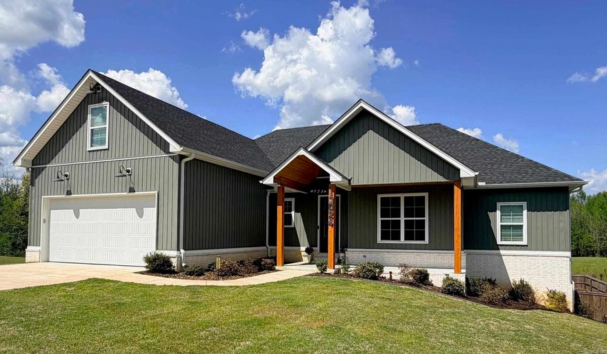 Fresh, inviting, and beautifully maintained—this 2023 home offers the feel of new construction without the wait, perfectly positioned on nearly an acre at the end of a quiet cul-de-sac.  Step inside to an open-concept layout filled with natural light, warm wood accents, and thoughtful design throughout. The kitchen is a true centerpiece, featuring quartz countertops, custom cabinetry, floating shelves, and a spacious island that flows effortlessly into the living area with a cozy wood-burning fireplace.  The primary suite is designed for comfort and convenience, highlighted by an oversized walk-in closet with direct access to the laundry room. A large upstairs bonus space with its own half bath offers flexibility for a media room, home office, or private guest retreat.  Out back, the setting truly shines. The neighboring pond provides a serene backdrop for watching deer and wildlife right from your own covered porch. The fully fenced backyard offers both privacy and space to relax, play, or entertain. With abundant storage, modern finishes, and a setting that feels tucked away while still being convenient, this home delivers the best of comfort, style, and scenery.