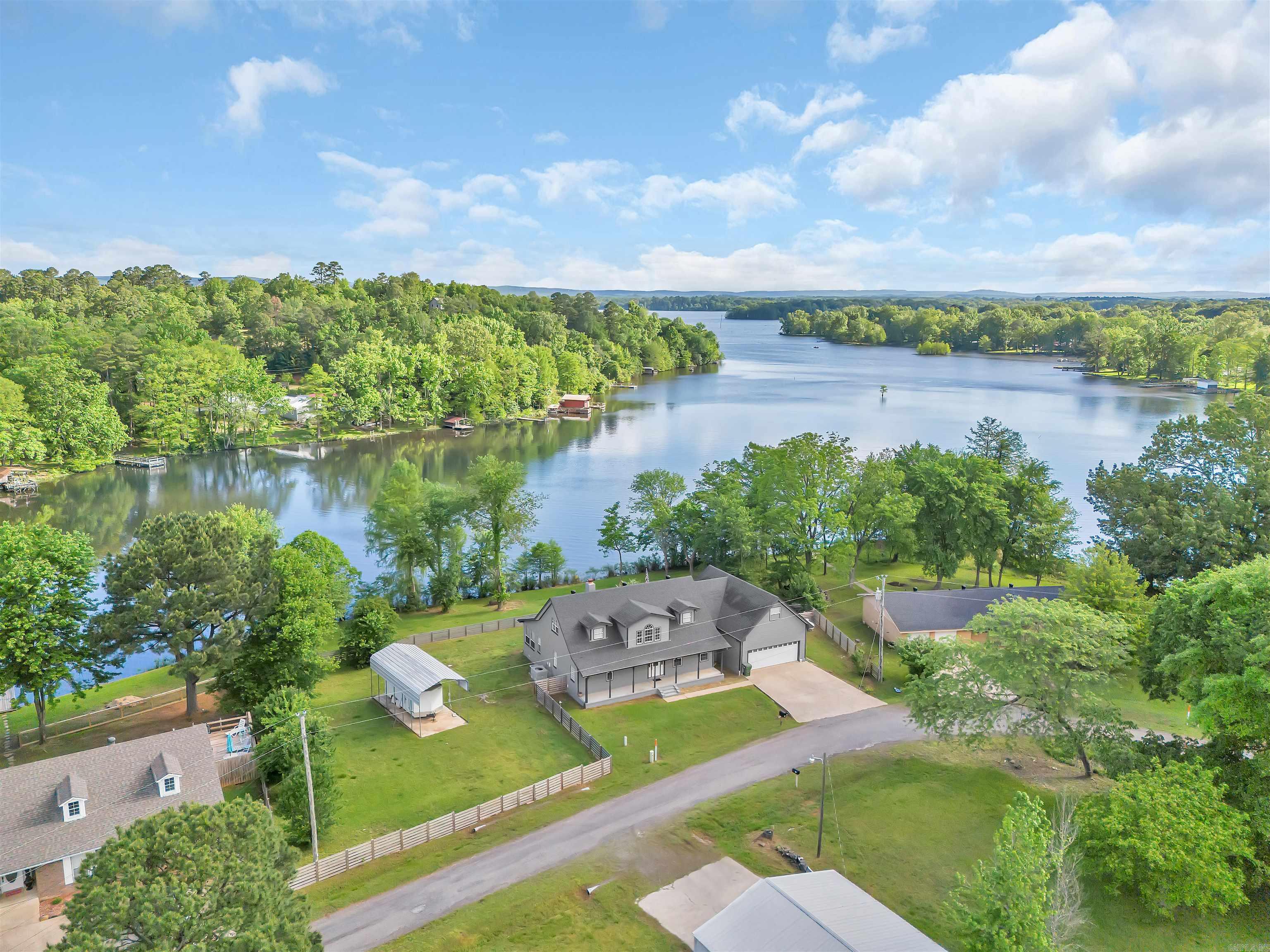 Fully Remodeled Lakefront Home on Harris Brake Lake! Enjoy 210’ of shoreline on Arkansas Game & Fish Commission’s 3rd largest lake. This stunning home has been completely transformed with attention to every detail—see the full list of upgrades in the photos! This home features 4 bedrooms, 3.5 bathrooms all wrapped into 3,573 sq/ft. Start your mornings with coffee on the brand-new 20’x30’ deck while your pets enjoy the fully fenced backyard. Inside, the kitchen offers lake views from the window above the sink, making everyday cooking a treat. The property also includes a spacious garage apartment with 1 bed, 1 bath, living area, and a kitchenette below—perfect for guests, rental income, or multi-gen living. It features a private entrance and optional access from the main home. There is covered RV parking on the property. For those needing extra space, a 30’x40’ shop on .6 acres is available for purchase separately. Don’t miss your chance to enjoy lake living at its finest—move-in ready and waiting for you!