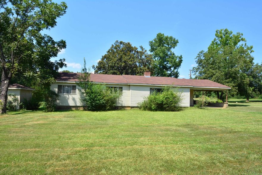 Nice ranch home on a beautiful 6.9 acre lot. The front half of the lot with the home is sprinkled with a few mature trees, several pecan, and a nice lawn, The back half of the lot is completely wooded. The home has the original solid tongue and groove  pine paneling in the living and kitchen areas. Luxury Vinyl Plank flooring has been added throughout the home. The baths have tile floors. The full bath has been updated with a large walk in shower. It also has a shop building for storage or a workshop. Plus an addition 10X10 outside storages building. Great location, Convenient to back gate of Little Rock Air Force Base and schools. Right by two great Restaurants! Smokin' Buns and Shayne's Cafe!! Come check this one out! AGENTS: SEE AGENT REMARKS