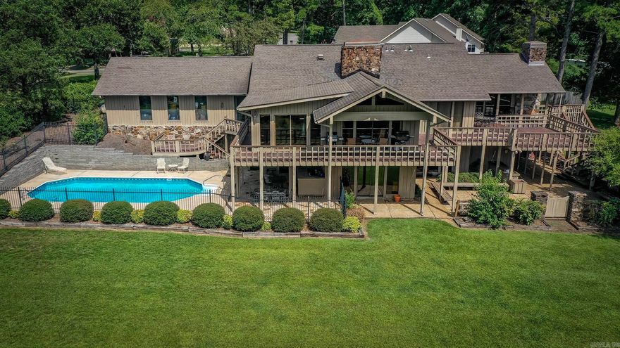 Paradise Awaits at this Lakefront home overlooking Greers Ferry Lake.  Step into your dream home, where tranquility meets breathtaking sunsets. Nestled in this highly coveted area, this magnificent lakefront property on a double lot boasts unparalleled views of the serene lake. Let your days end with awe-inspiring western sunset vistas from the comfort of your own backyard. As you enter this expansive residence, discover a blend of luxury & practicality that promises endless potential. The heated in-ground pool, overlooking the glittering lake, beckons you for a refreshing dip as you soak in the natural beauty around you. Entertaining is elevated to an art form here, with an outdoor kitchen area, a generous covered and uncovered deck, & elegant stone patios perfect for gatherings under the stars. Inside, experience the warmth and charm of three inviting fireplaces, ample storage solutions, a large pantry, and two generously-sized walk-in master closets catering to all your needs. The lower den area provides a cozy retreat, making it an ideal space for relaxation or entertaining. A whole house generator that provides electric when a power outage occurs. Safe room. See agent remarks.