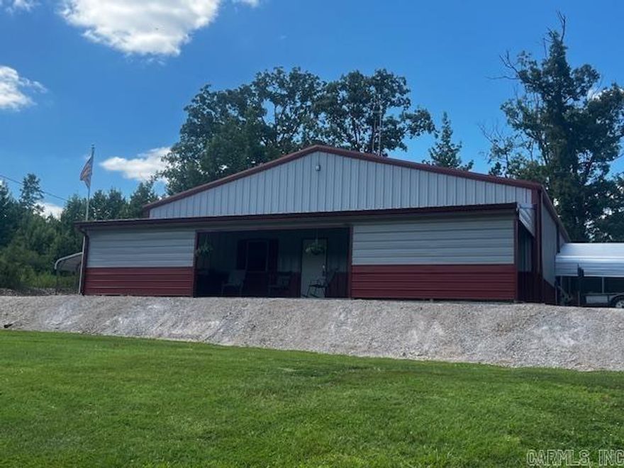 Unique barndominium w/ 1480 sq ft living space, 1480 sq ft attached garage, and 1480 sq ft upstairs storage area all setting on approx. 10.73 acres just waiting for you to experience the country life. Living area has a split floor plan w/ large open living, dining, and kitchen combo. With 12 ft ceilings the heated and cooled garage has 2 roll-up-door for easy pull through, and is big enough to park your RV and/or boat with room to spare. The interior is rustic with tongue and grove pine walls, vinyl ceiling, tin shower surround yet has all the modern comforts you would expect. Neighborhood amenities include gated entrance and stocked lake.