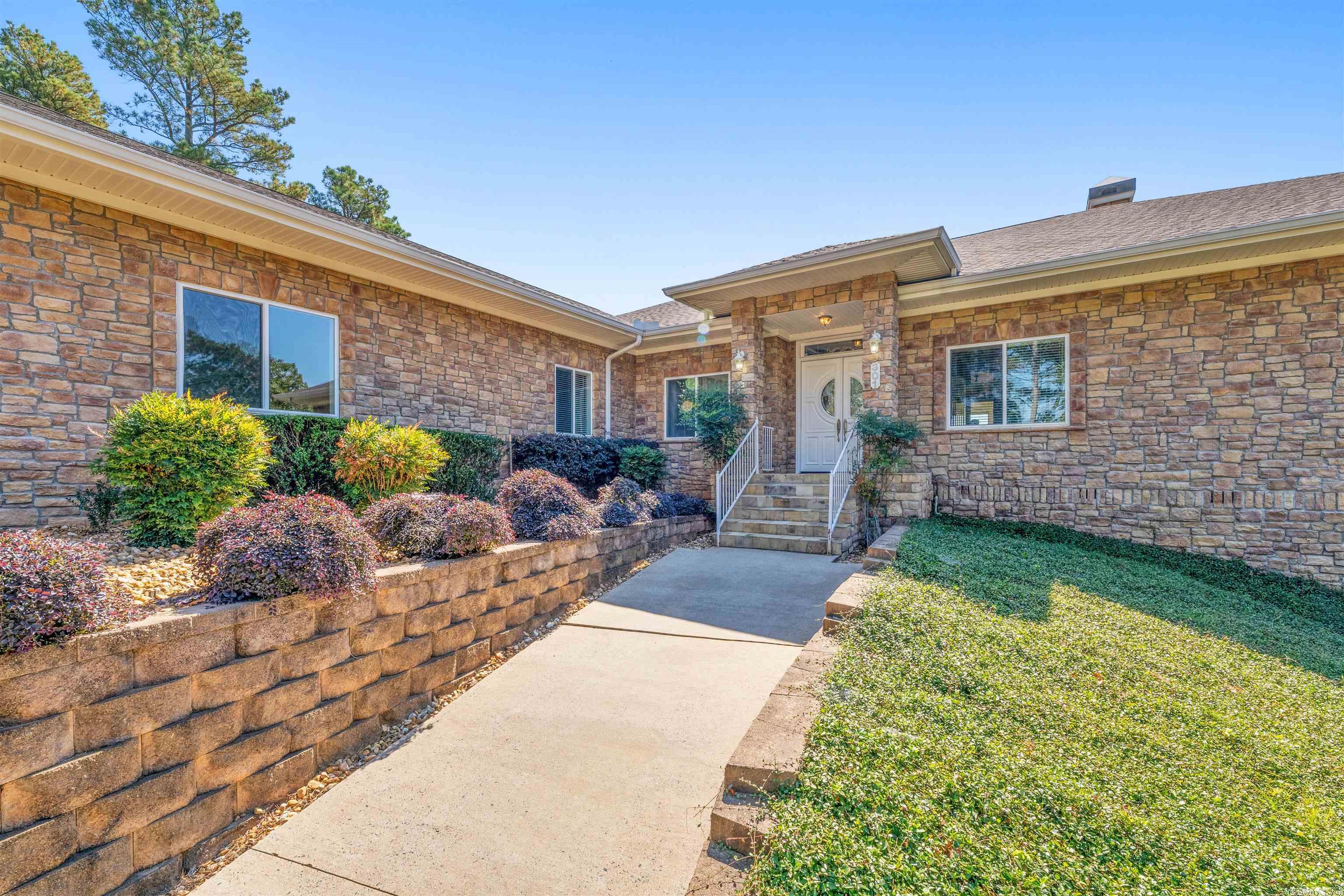 Watch gorgeous Sunrises & Sunsets over the Arkansas River in this exquisite custom built home while having Privacy & Seclusion! Beautifully situated on 1.88 acres, you can feel close to nature but you are still IN TOWN! Enjoy stunning views from your Incredible CHEF'S KITCHEN while creating delectable dishes to serve while entertaining in the beautiful open gathering space! Just off of the kitchen is the butler's pantry w/tons of storage! The Primary Suite is over 800 square feet creating that palatial feel! Step down from a heated floor into a beautiful Roman tub in the Primary Bathroom for TOTAL relaxation! 2 large bedrooms on the other side of the home have a connecting bathroom. The 4th bedroom w/private bathroom makes the perfect guest suite or home office! Downstairs you will find the HUGE game room with wet bar, full bathroom and a FLEX ROOM that you can use as a theatre room, man cave, arcade - endless possibilities! There is also a private entrance on the lower level should you prefer to use this as an in-law dwelling. Beautiful Stone Exterior! Massive storage! Oversized 3 car garage with charging capability for your Tesla! This home has MANY hidden gems! See Agent Remarks