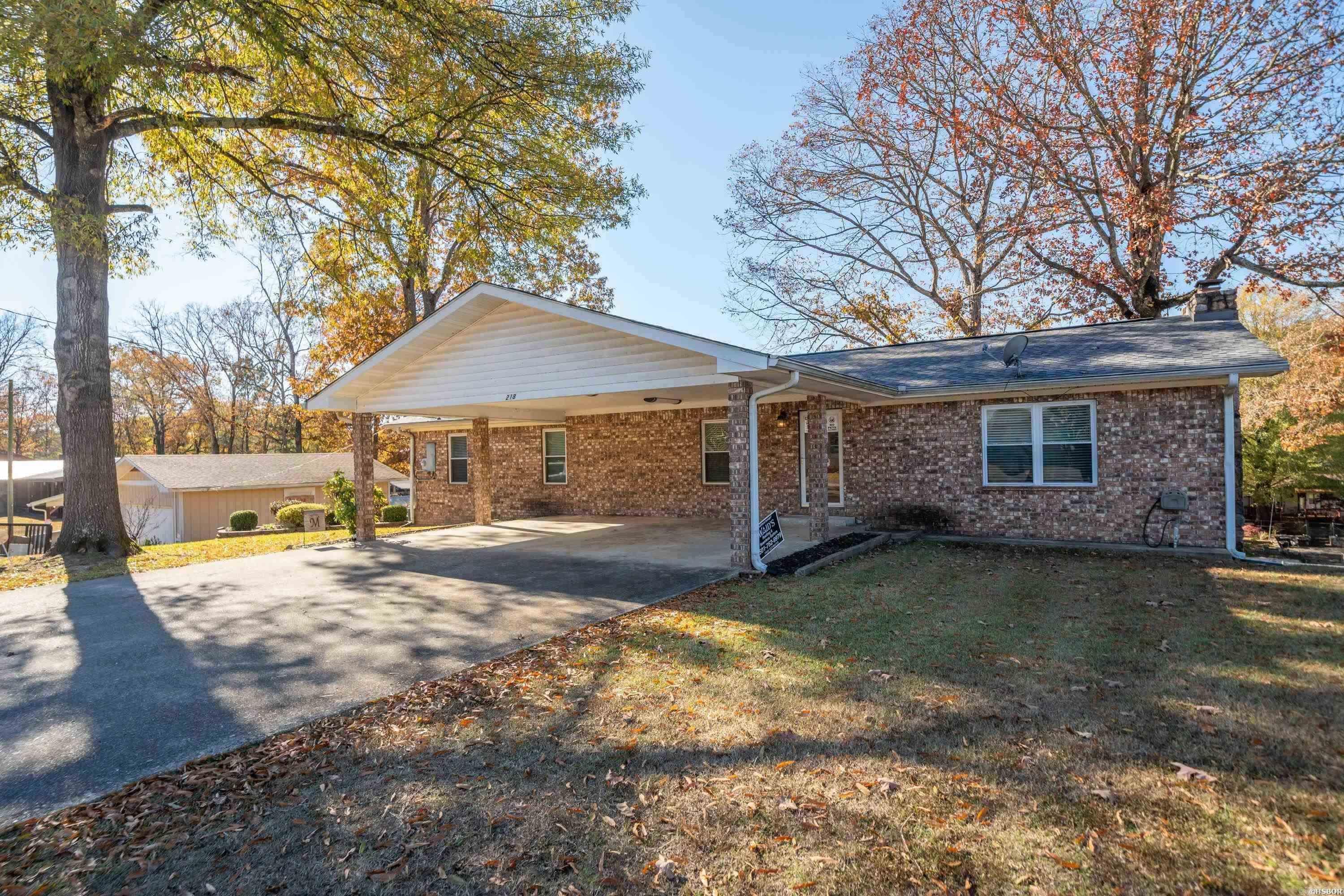 Fantastic price on this 5 bedroom, 3 bath home on Lake Hamilton with approximately 100' of lake frontage. This home has been fully updated and is currently being used as a short term rental. The home sleeps up to 16 guests and is being sold fully furnished, with all contents conveying to the new buyer. Brand new roof was installed in 2024. The property has an expansive outdoor deck overlooking the lake, along with a single stall covered boat slip. This lake property would be particularly ideal for large family or someone looking to add to their rental portfolio.