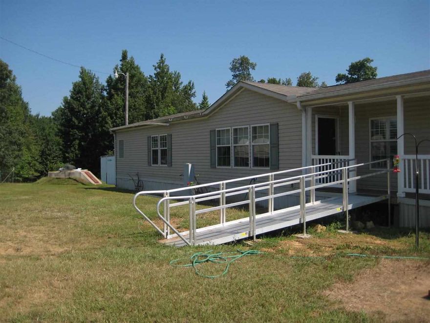 6 acres total - with 3 bed 2 bath 2007 Double Wide Mobile Home 28x72 Aluminum Ramp to porch with storm shelter, 2 car carport, outside storage container 48 x 102 and 20 foot tool shed. Z - Roof -  Fiberglass Roof,  The first 3 acres left of the home has pond, water setup and septic and has Fruit Trees (2 apple, 2 Peach, 3 Muscadine, 2 pear, 3 Cherry, 1 Fig, 3 Walnut, 1 Pecan, 1 pomegranate, 1 Apricot, 1 Nectarine)