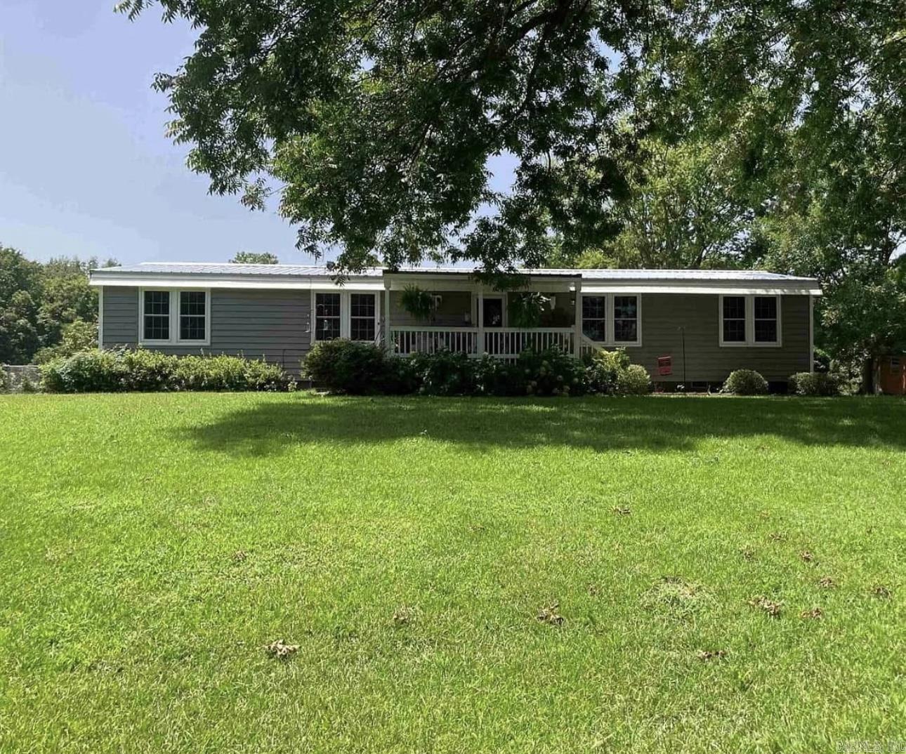 Beautifully maintained mobile home! Permanently attached! River view across road! 3Br, 2Ba, laundry room, living room, dining room, kitchen, laundry room, inviting covered front porch, newer 1car garage with electric opener. This yard or house has never flooded or held water! Flood insurance will be required! Part of backyard enclosed with chain link fence! Newer metal roof! New A/C compressor, siding 3-4 years old! New sewer line! New anchors for permanent foundation! Nice, quiet area to enjoy to the max!!