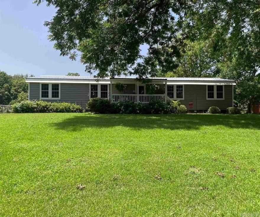 Beautifully maintained mobile home! Permanently attached! River view across road! 3Br, 2Ba, laundry room, living room, dining room, kitchen, laundry room, inviting covered front porch, newer 1car garage with electric opener. This yard or house has never flooded or held water! Flood insurance will be required! Part of backyard enclosed with chain link fence! Newer metal roof! New A/C compressor, siding 3-4 years old! New sewer line! New anchors for permanent foundation! Nice, quiet area to enjoy to the max!!