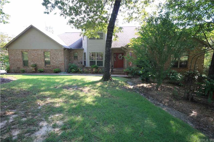 Beautiful setting on 1.3 acres. Custom built 1owner home. In excellent condition. Open plan, lots of windows affording wonderful views of the lake. Over sized deck great for relaxing. Very private. Nice sun room. Spacious master, master bath and office down. 2 nice sized extra bedrooms up. Tray ceilings in master and great room. Formal dining plus separate breakfast area. Nice kitchen with breakfast bar and stained cabinets. 3 car garage. Pretty landscaping. In ground irrigation system. Security system.