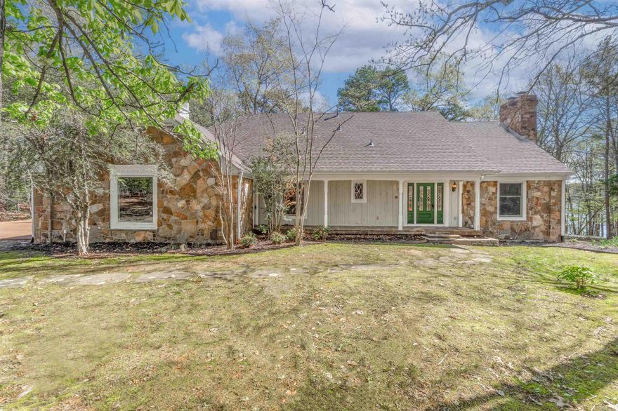 LAKEFRONT HOME ON GREERS FERRY LAKE AT THIS PRICE??? The off-street serene setting offers an easy stroll to water's edge. And not a neighbor in sight!  Almost 250' of shoreline.  This is an excellent, well-constructed custom home by Steve Swenson. Relax in the screened room with tiled floor, & enjoy the view, fresh air, wildlife, birds, & quiet natural surroundings.  The 2-story home has 4 BR, 2.5 Ba, a hearth room with wbfp, a formal living area with gas f/p, dining areas, mudroom with LG Washer/Dryer on pedestals, & lots of storage!  The grand front entrance has a lovely chandelier & sweeping staircase to upper level.  Bathrooms have cultured marbled fixtures.  Other features include a 2018 roof, 2 heatpumps, wired for RV or generator, 2-car garage, clean crawlspace, floored attic., & inside storage.  The exterior stone  work with Hardiplank is stunning, as is the large back patio.  Easy-care yard with extra landscaping and mulched flower beds.  There is no other Fairfield Bay lakefront home on the market at the great price point.  Call soon for a private showing.  By appointment.