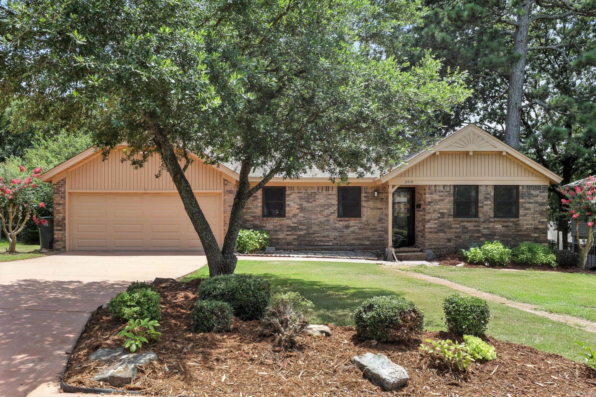 This 3-bed, 2-bath home in West Little Rock offers 1,740 sq ft of updated charm just steps from the community pool. Inside, enjoy vaulted ceilings with wood beams, a cozy painted brick fireplace, two spacious living areas, and fresh paint throughout. The kitchen features granite countertops, subway tile backsplash, stainless appliances, and a new dishwasher (2025). Both bathrooms have been stylishly renovated with granite and tile finishes. Major updates include: roof (2020), water heater (2021), garbage disposal (2022), back gutters (2021), and a brand-new deck (2024). The crawl space has a vapor barrier installed for added peace of mind. The fenced backyard and oversized raised deck are perfect for entertaining or relaxing under the trees!