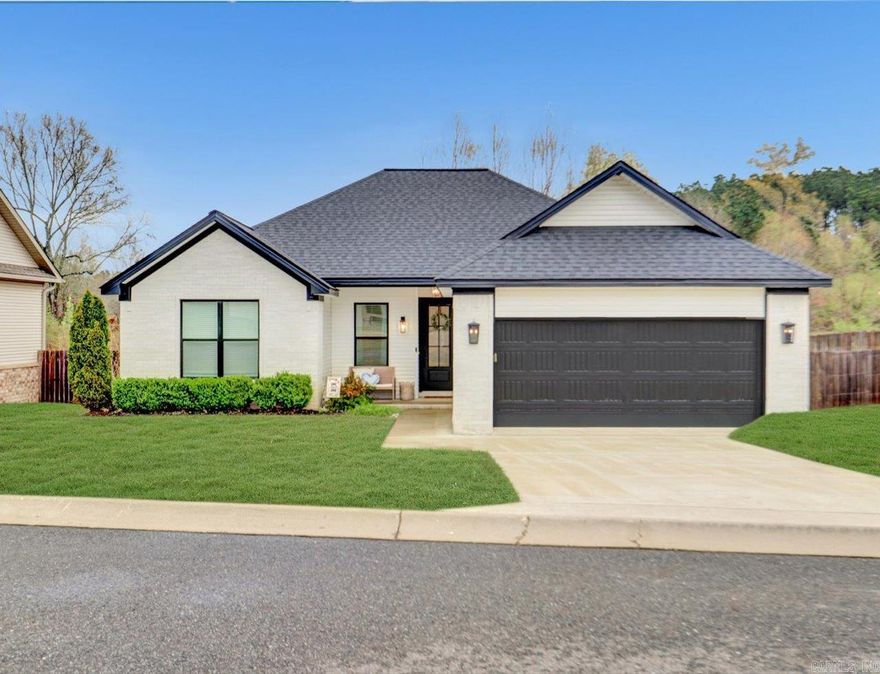 Welcome to 215 Windcrest Circle—an inviting one-owner, 3-bedroom, 2-bath home in the Lake Hamilton School District, thoughtfully built with custom upgrades and designed for comfortable living.  Inside, you’ll find a bright, open layout with vaulted ceilings, large windows, and a cozy gas fireplace. This home features builder-selected upgrades throughout, including enhanced lighting, flooring, fixtures, crown molding, and quartz countertops. The farmhouse sink in kitchen; stainless steel appliances, a gas range, and a functional layout that opens to the main living area—ideal for both everyday living and entertaining.  The split-bedroom floor plan provides added privacy, while the primary suite offers a relaxing retreat. Step outside to a fully fenced backyard backing to a pond and wooded area—no rear neighbors—creating a peaceful, private setting.  Additional highlights include a two-car garage, move-in ready condition, and convenient access to shopping, dining, and local amenities.