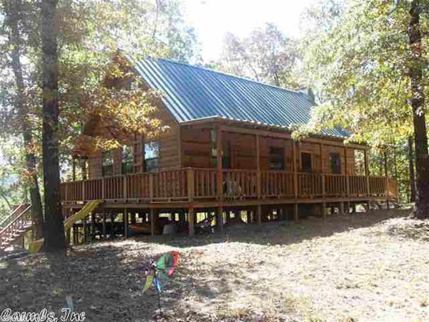 Beautiful cabin on 2.99 acres on the Caddo River! The cabin is a 2 bedroom, 1 bath with a loft for an extra bonus. It features a rock fireplace, front and back porches, porch swings, a deck with picnic table, stairs going down to the river, and a breathtaking view. Selling with furnishings (list is in the office). This is the perfect vacation home!