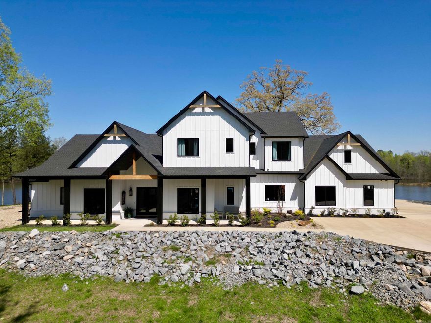This property is truly a one of a kind place.  Located in West Little Rock, just 7.5 miles to Bass Pro Shops, 8.5 miles to Promenade at Chenal, and 17 miles to downtown L.R.  The main house boasts 5810 sq. ft., it has 6 bedrooms, 5 1/2 baths, formal dining, office, an amazing upstairs gathering room that is central to each of the upstairs bedrooms.  An amazing master suite with soaking tub, huge walk in shower room, and the dream master closet.  Amazing views of the private lake abound.  The kitchen has spared nothing.  Beautiful quartz counter tops, top of the line Kitchen Aid appliances including the 6 burner double oven gas range, ice maker and double door refrigerator/freezer.  In the living room the vaulted ceilings with exposed beams offers a great place for entertaining or having family gatherings.  If it gets to crowded just step out back onto the covered patio with outdoor kitchen and enjoy the view of your very own 25 acre lake.  There is a safe room located inside the huge 4 car garage, of which one space is currently set up as the exercise room.  Prewiring for an electric charging station.    The second home is 1800 sq. ft. 3 bed 2.5 bath and gorgeous as well.