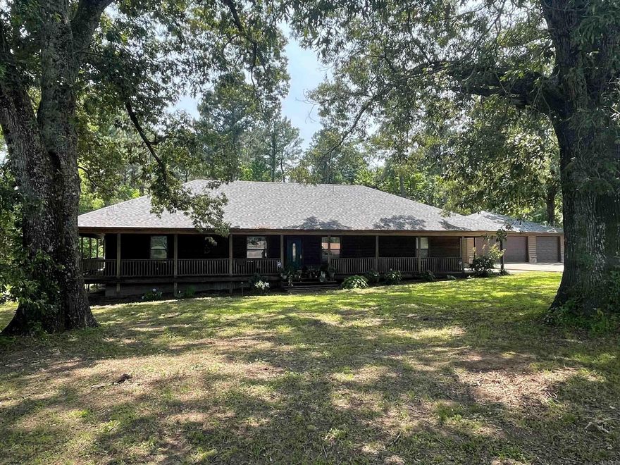 Charming 3BR/2BA home on 3 beautiful acres in Bismarck! Spacious open-concept layout with living, dining, and kitchen flowing seamlessly--plus a bright sunroom and upstairs bonus room perfect for an office, playroom, or guest space. Enjoy outdoor living with a full wrap-around porch and an above-ground pool with deck for relaxing or entertaining. Detached 2-car garage plus an additional garage/workshop--fully insulated with water connection--offers incredible space for hobbies, storage, or home business. Log-style exterior adds rustic curb appeal, while modern amenities like central HVAC and updated finishes provide comfort and functionality. Located in a peaceful rural setting just minutes from town, schools, and nearby lakes. Plenty of room to garden, expand, or simply enjoy the quiet countryside. This unique property blends charm, space, and utility--don't miss it!