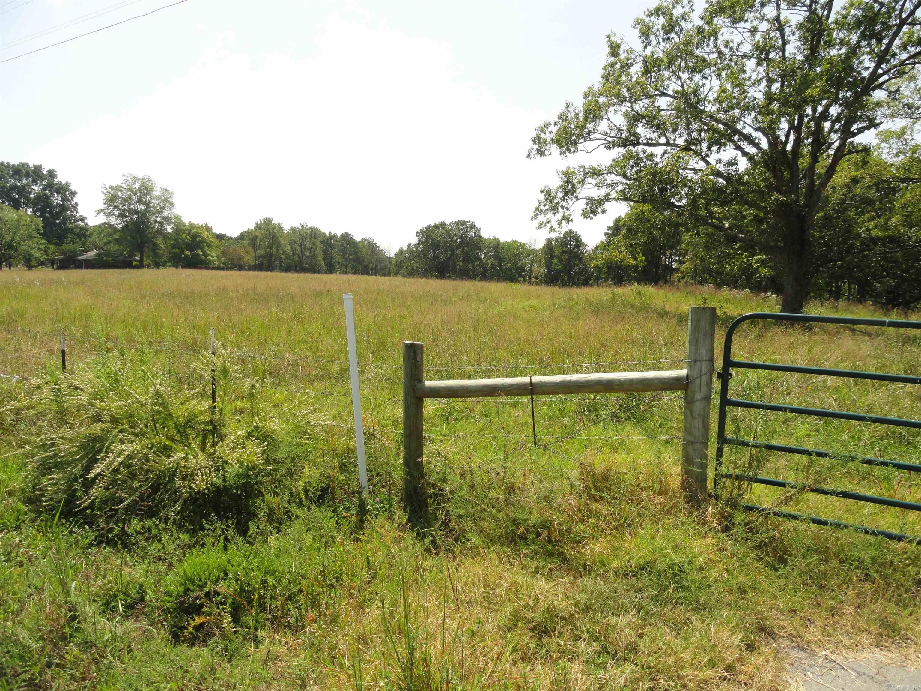 Beautiful 10-acre tract with with approx. 5 acres of open pasture and 5 acres of woods, offering a perfect mix of open space and privacy. 900ā of Hwy 65 frontage provides easy access, and the level terrain near the road makes a great homesite or business location. Property includes an existing cement slab ready for a small home or storage building, plus an old open-air barn/shed. Water and electric available at the highway. Land gently slopes downhill into the wooded area, ideal for exploring or creating a private retreat. Just minutes to Greers Ferry Lakeāenjoy fishing, boating, and camping nearby! Only 5 miles to Clinton, AR, where youāll find a Walmart Supercenter, hospital, small airport, building supply stores, and restaurants. Clinton offers small-town charm with modern amenities and is home to the famous National Chuck Wagon Races. Conway, AR is only 48 minutes away and Little Rock is 90 minutes away. Great opportunity to build your dream home, hobby farm, or weekend getaway in the heart of the Ozarks!