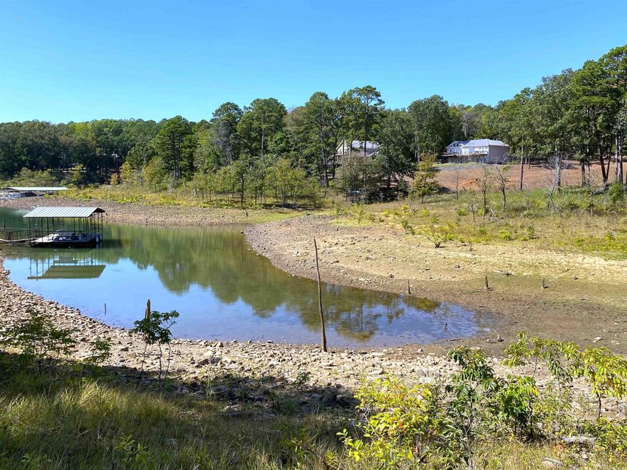 7 wooded acres nestled along the picturesque shores of Greers Ferry Lake. This remarkable property features an exceptional white line and is situated in a coveted boat dock zone, this parcel, subject to approval from the Corps of Engineers, presents a unique chance to build your dream lakeside retreat. Set within a well-established neighborhood, this property epitomizes serenity and seclusion. Imagine waking up to the soothing sounds of nature and enjoying the privacy that comes with the surrounding woods. Whether you envision a cozy cabin or an expansive estate, the possibilities are endless. With water, electricity, and high-speed internet readily available, you can seamlessly blend modern convenience with the tranquility of lakeside living. There is also a boat launch ramp only 1000 feet away from the property. Call a agent today for details and don't let this one slip past you!