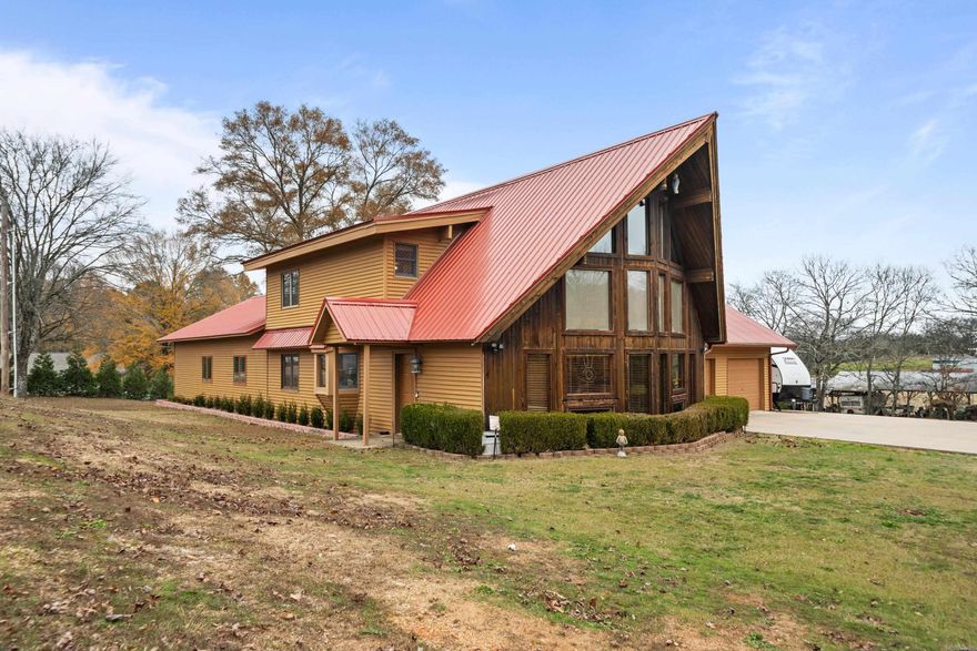 Meticulously built and maintained 4-bedroom, 3-bathroom home on 2 (+/-) acres with 60x40 workshop, detached 1bed/1bath apartment, neighborhood lake access and more! This thoughtfully designed home was built with solar efficiency in mind. Its orientation maximizes natural sunlight during winter months while the summer sun is directed away to keep the interior naturally cooler. Inside you will be greeted by a breathtaking wall of windows, a stunning natural stone fireplace, and soaring vaulted wood-plank ceilings. The extraordinary primary suite is over 1,000sq/ft and features a cozy fireplace, boutique-style walk in closet, plantation shutters, & private patio access. Home has two fireplaces, whole-home generator, two car garage, two HVAC units, two water heaters, cedar lined closets, plus lots of extra storage including a 29ft rack for hanging clothes. Workshop has 3 roll-up bay doors, including an oversized 14-foot door, ideal for RV storage, along with a 50amp electrical service, 1/2bathroom, & storage room. Lovingly maintained by the original owners, this home offers a unique blend of comfort, character and ample space.