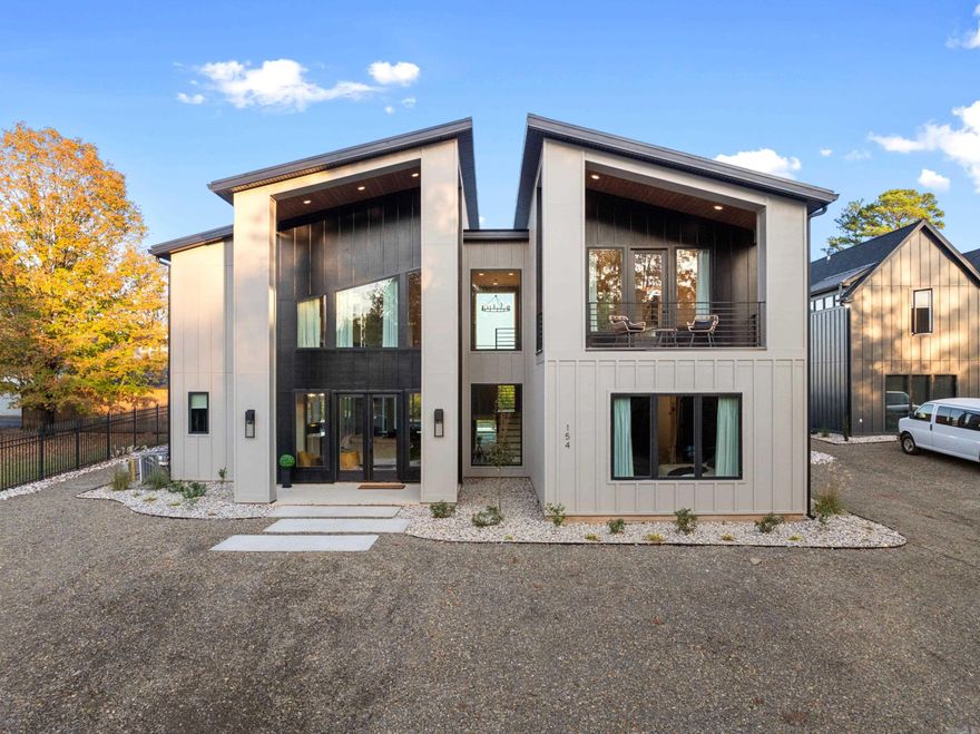 Experience luxury lake living on Lake Hamilton with this 5 bed, 3.5 bath home designed for entertaining and relaxation. The open-concept layout includes a game room and a bunk room with two queen-over-queen bunks, making it ideal for hosting large groups or vacation rentals. The home is being sold fully furnished, offering a turnkey opportunity for a lake retreat or investment property. Outdoor amenities create a true resort-style setting with a pool and attached spa, outdoor kitchen, outdoor living room with oversized TV, bocce ball court, and low-maintenance AstroTurf and rock landscaping. With laundry rooms on both levels and incredible gathering spaces inside and out, this Lake Hamilton property is built for making memories.