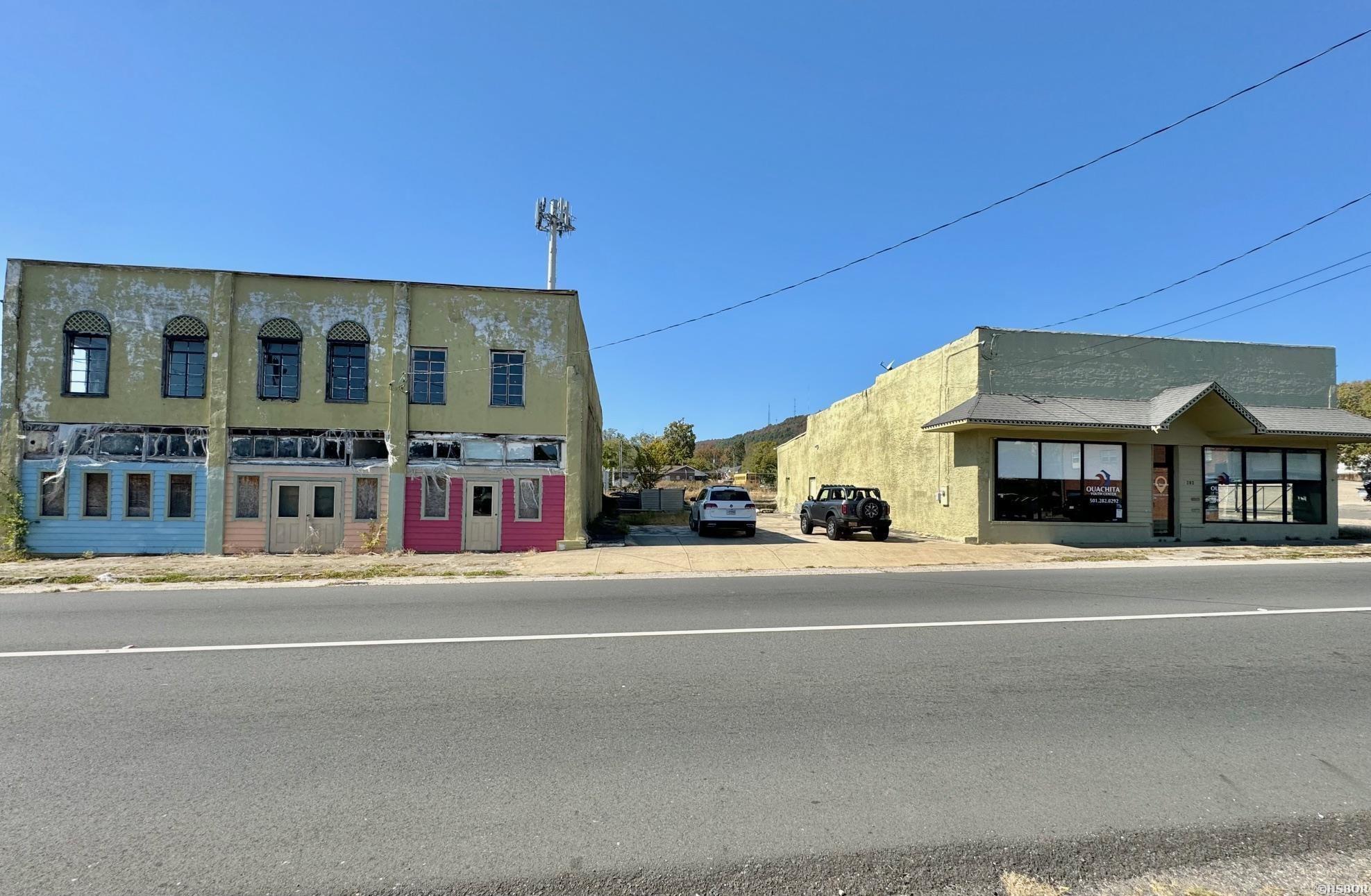 Fantastic price on these two commercial buildings in Hot Springs, located in a high traffic area near downtown Hot Springs. Zoned C-2 commercial. The office building is approx. 3500 sq. ft. and was renovated a few years ago - move in ready. The office building also has a shop area in the back. The adjacent two story building is structurally sound but needs a full renovation. Lots of possibilities with that building! All combined, it's over 11,000 sq. ft. of space. The buildings share a parking lot between them.