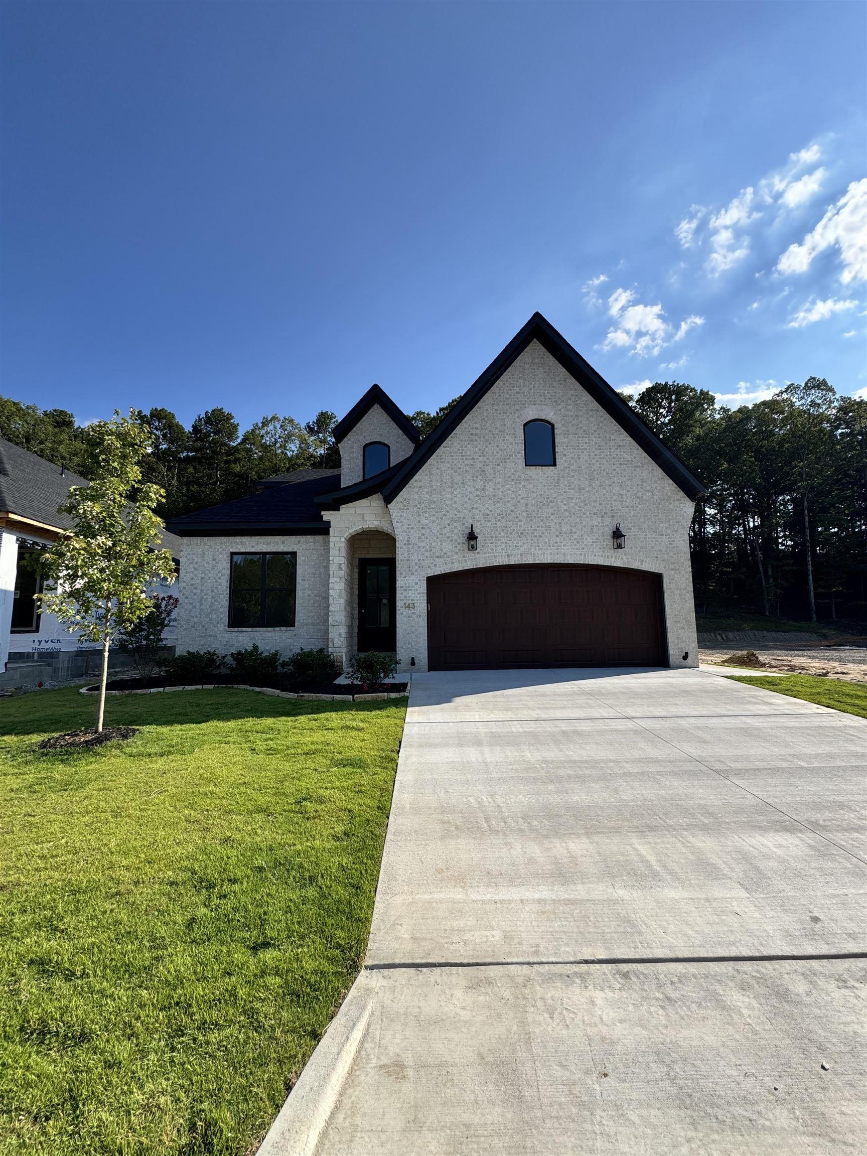 Walking distance to the brand NEW POOL & PARK area being built. This custom home boasts high-end features, including 10-foot ceilings and 8-foot wood doors. The spacious kitchen is a highlight, featuring a striking White Oak island and floor-to-ceiling cabinetry, top tier appliances. The expansive living and dining area is filled w/ natural light. This open space is enhanced by an 11-foot tall coffered ceiling. The living area features a stone-wrapped fireplace w/ built-ins on either side, complete w/ white oak floating shelves that tie the space together. The massive master suite offers an 11-foot tray ceiling, creating a grand ambiance, along w/ a cozy reading nook. The master bathroom is distinct, featuring a glass-enclosed shower, a spacious FS tub, and a double sink vanity. A large walk-in closet provides access to the conveniently located laundry room, which includes a sink. The downstairs also includes 2 additional bedrooms and a pro-designed full bathroom w/ tub wrapped in stylish tile. Upstairs, you'll find a full playroom, a fourth bedroom w/ walk-in closet, and a third full bathroom also tub wrapped in tile! One of a kind home!
