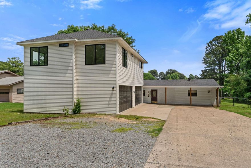 This versatile property offers space, comfort, and a beautiful setting. The main home features 3 bedrooms and 2 bathrooms, along with two separate living areas and a convenient kitchen/dining combo—perfect for both everyday living and entertaining. Step outside to a large back patio that overlooks an expansive backyard backing directly up to Lake Pauline, providing peaceful views and added privacy.  In addition to the main home, the property includes a spacious 4-car garage with an upper-level addition. This bonus space features an open-concept kitchen and living area, along with 2 bedrooms and 1 bathroom—ideal for guests or extended family. Sq ft approx., measurements encouraged. Agents see remarks.